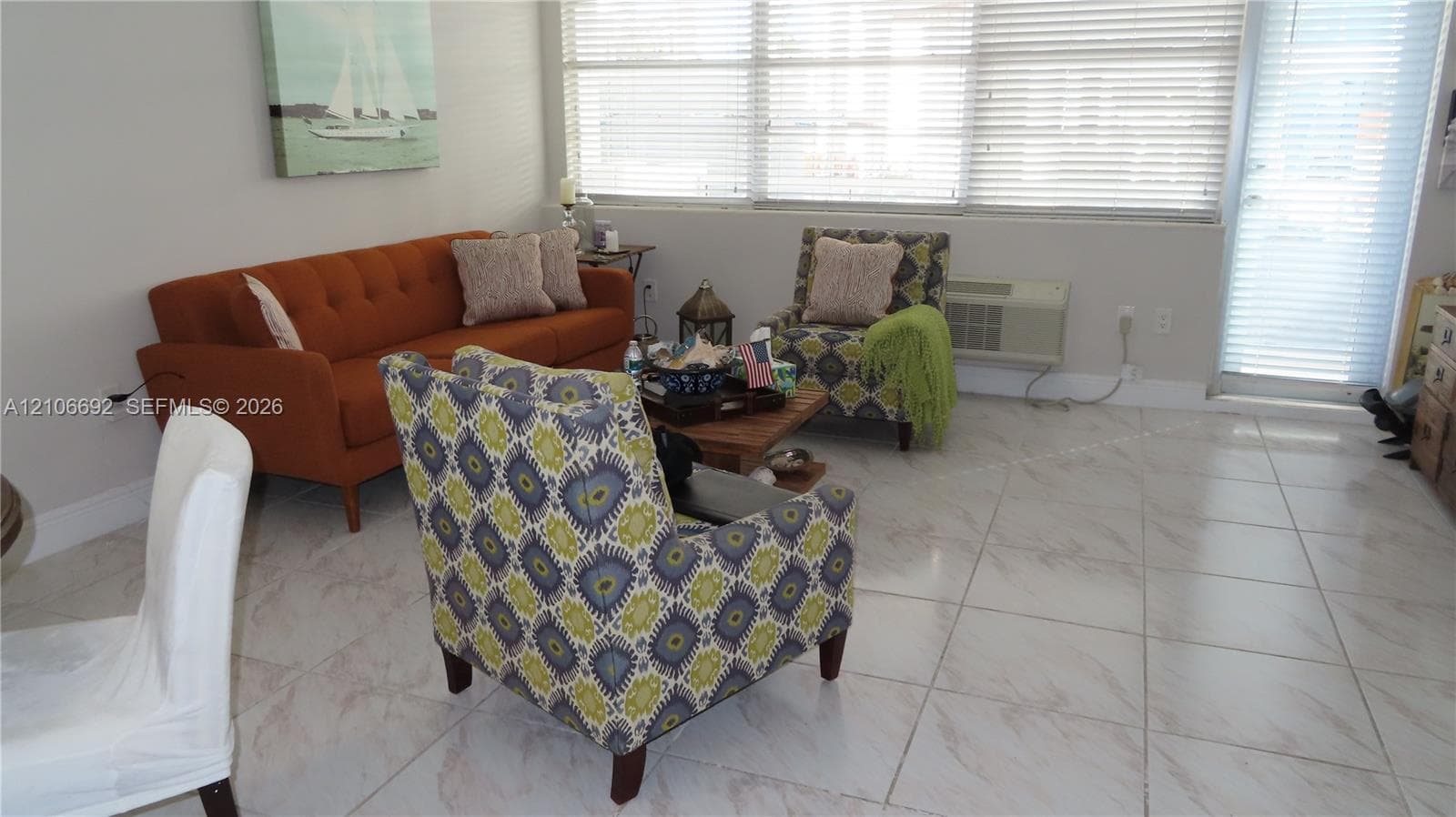 Large-format tile flooring, expansive horizontal windows with integrated blinds, and glass-paneled exterior door