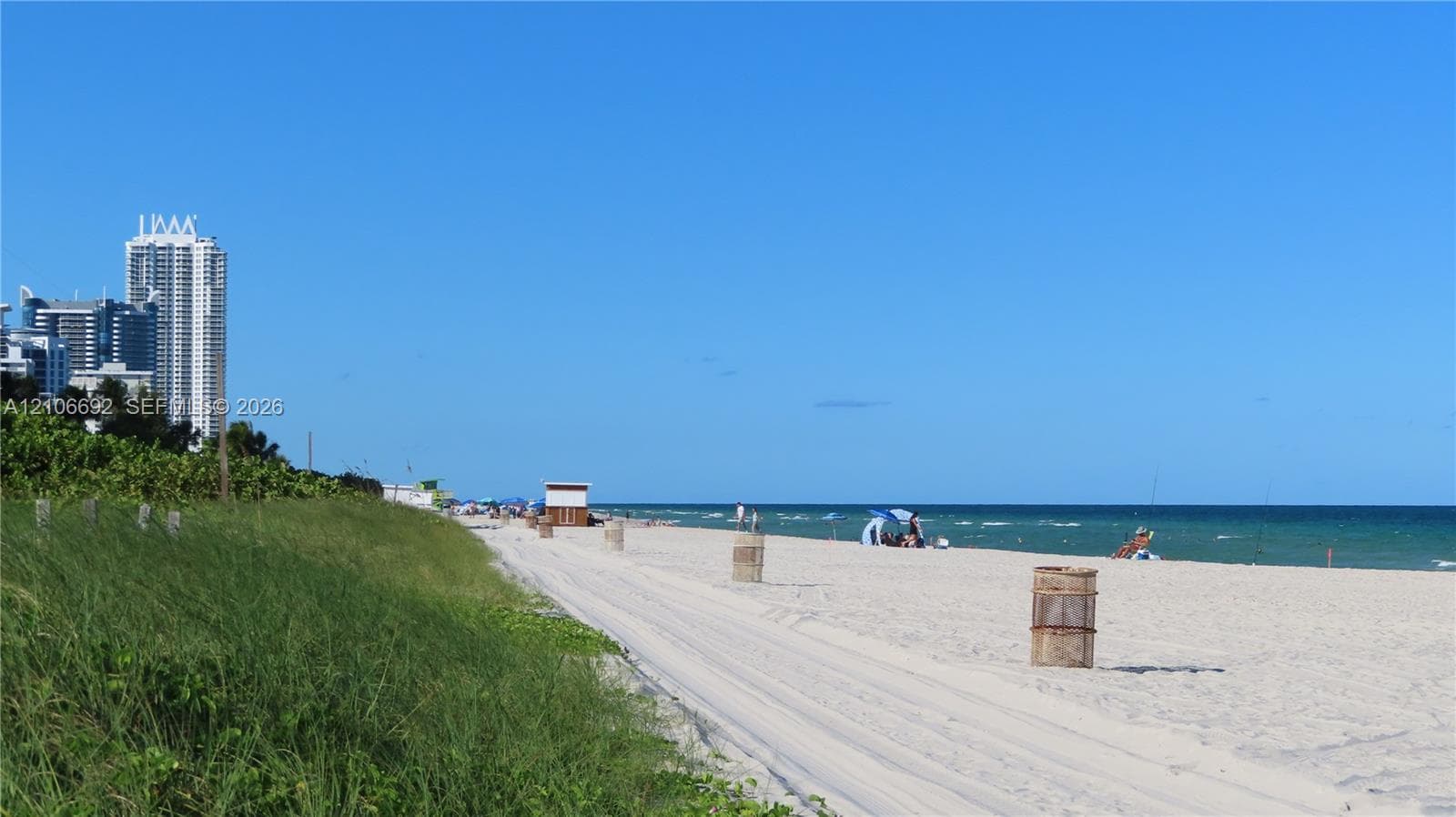 Coastal beachfront property featuring expansive sandy shoreline, native dune vegetation, and direct water access