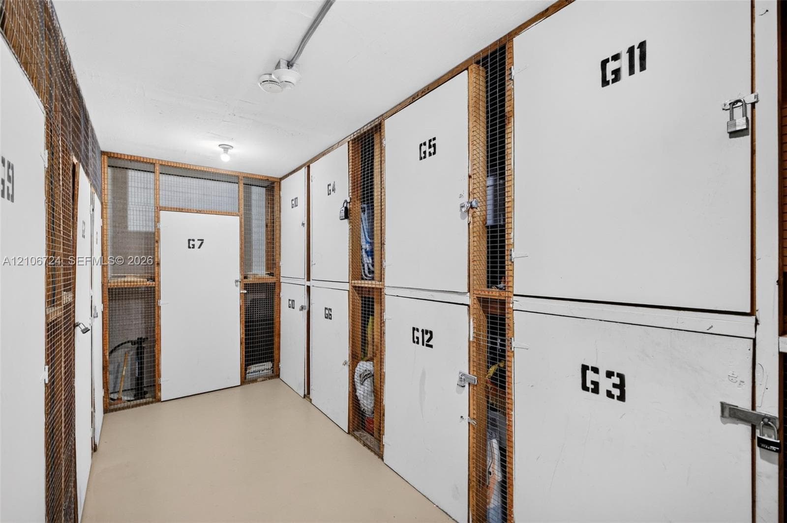 Dedicated storage area featuring numbered, secure lockers with mesh wire paneling and metal door hardware