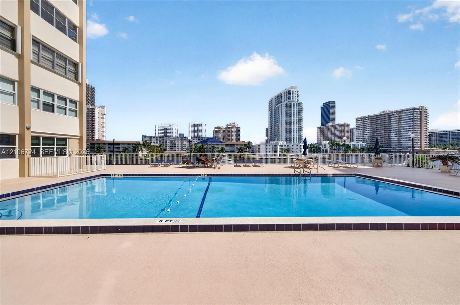 Rectangular swimming pool featuring a tiled perimeter, integrated lane marker, and surround with water-front exposure