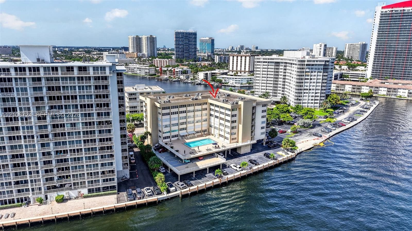 Mid-rise waterfront building featuring a rooftop swimming pool and direct bulkhead access