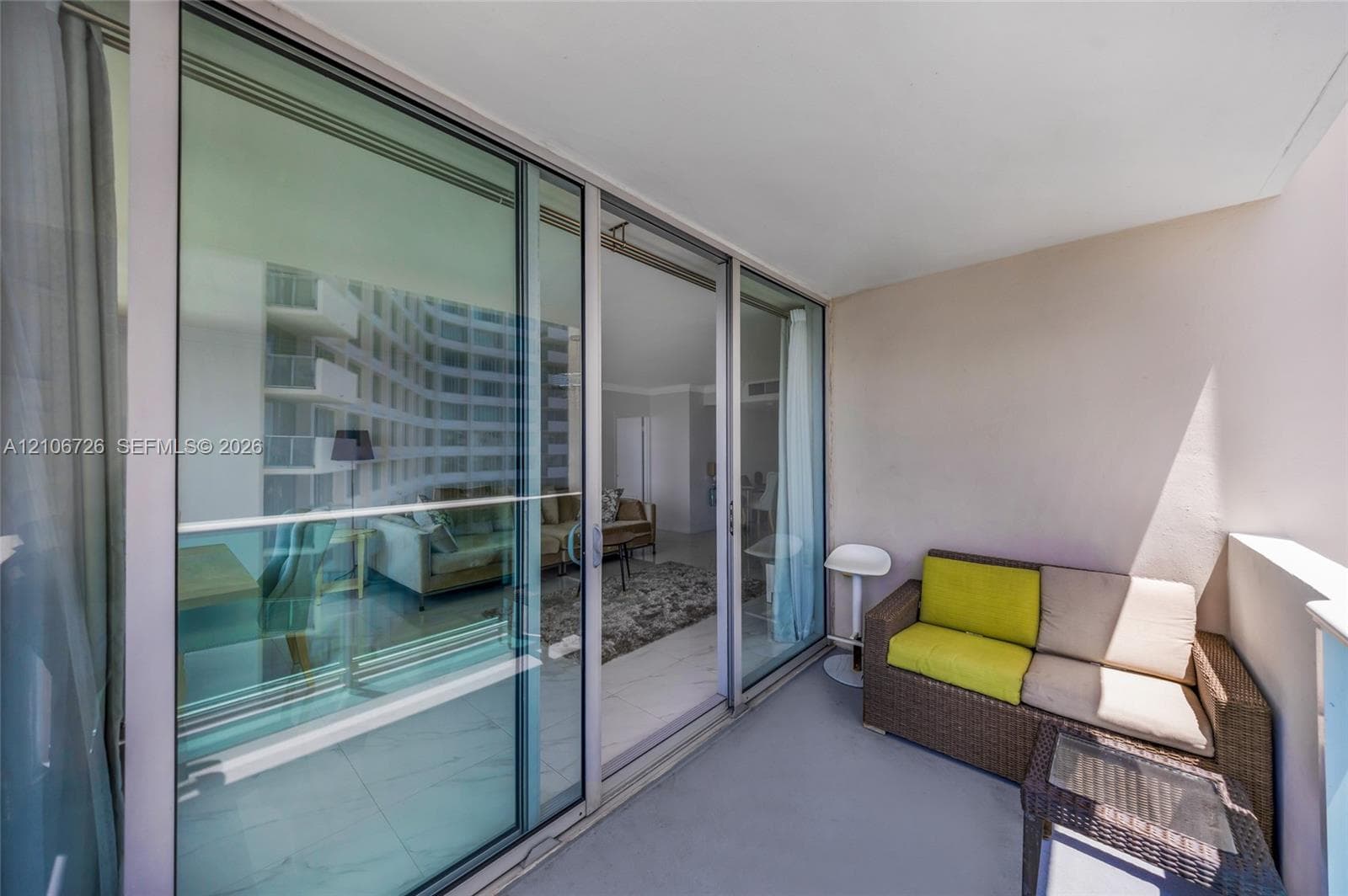 Covered balcony featuring glass sliding doors and neutral wall finishes
