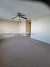 Neutral wall finish, wall-to-wall carpeting, and a ceiling-mounted fan with integrated light fixture
