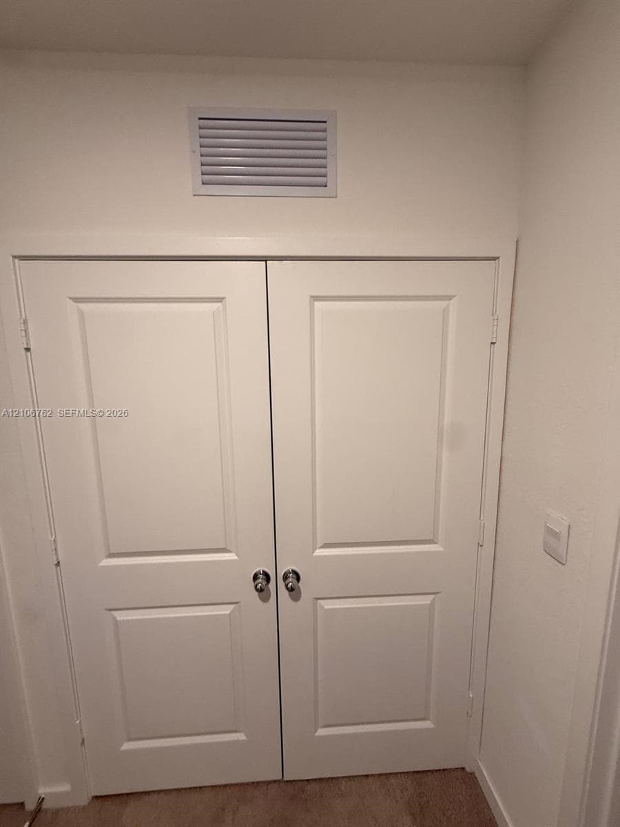 Double-panel interior doors with recessed detailing and metallic hardware