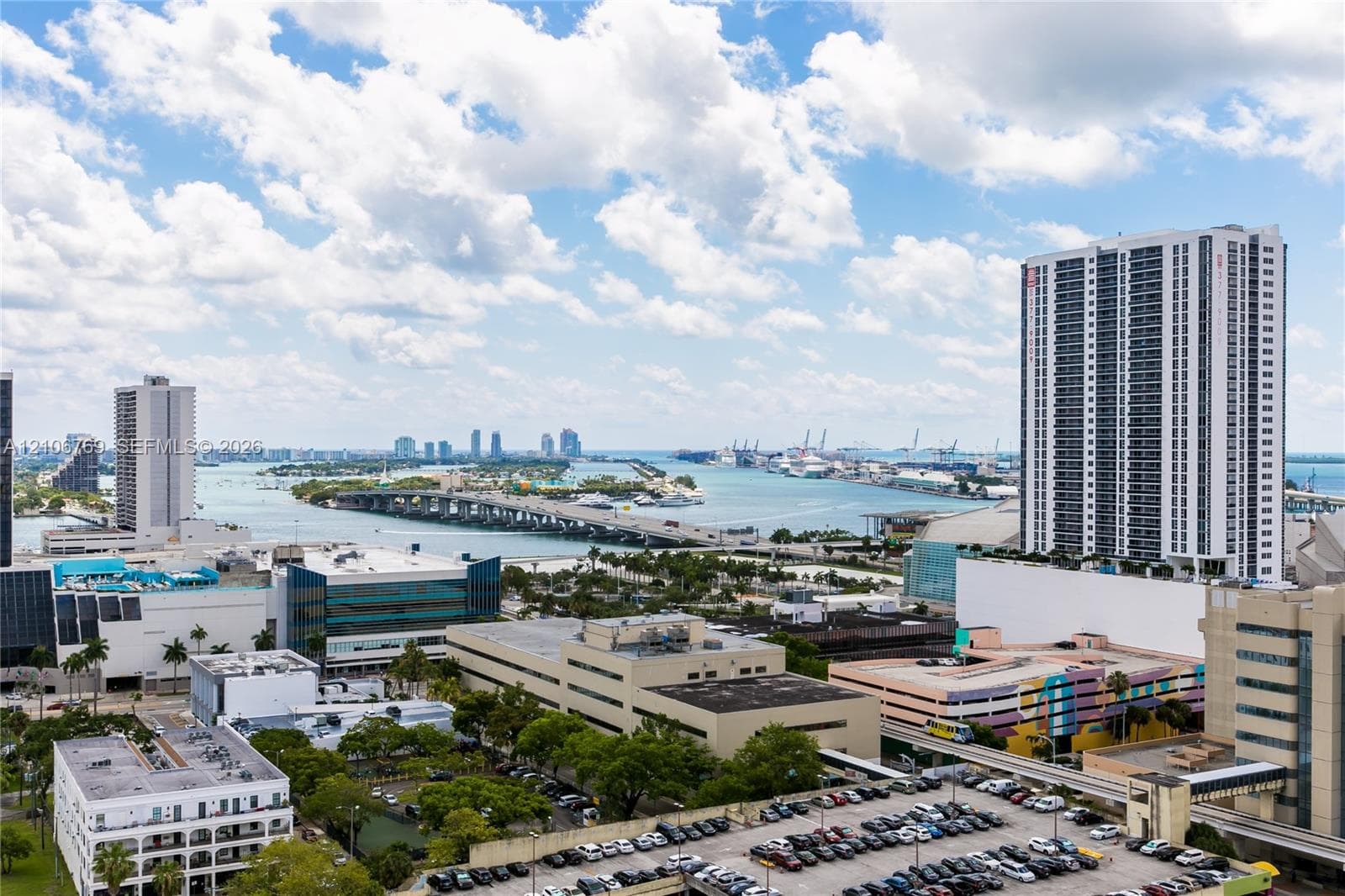 High-rise urban perspective featuring a skyline silhouette, expansive water access, bridge infrastructure, and coastal scenery