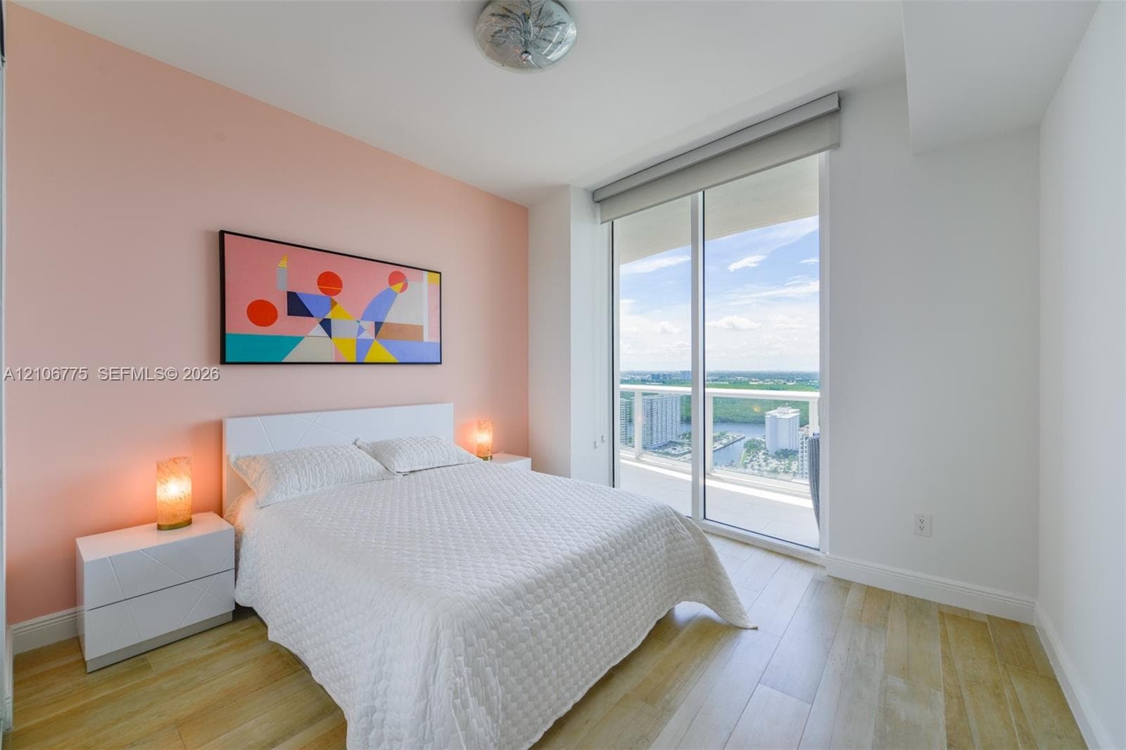 Wood-finish flooring, floor-to-ceiling glass sliding door, and private balcony