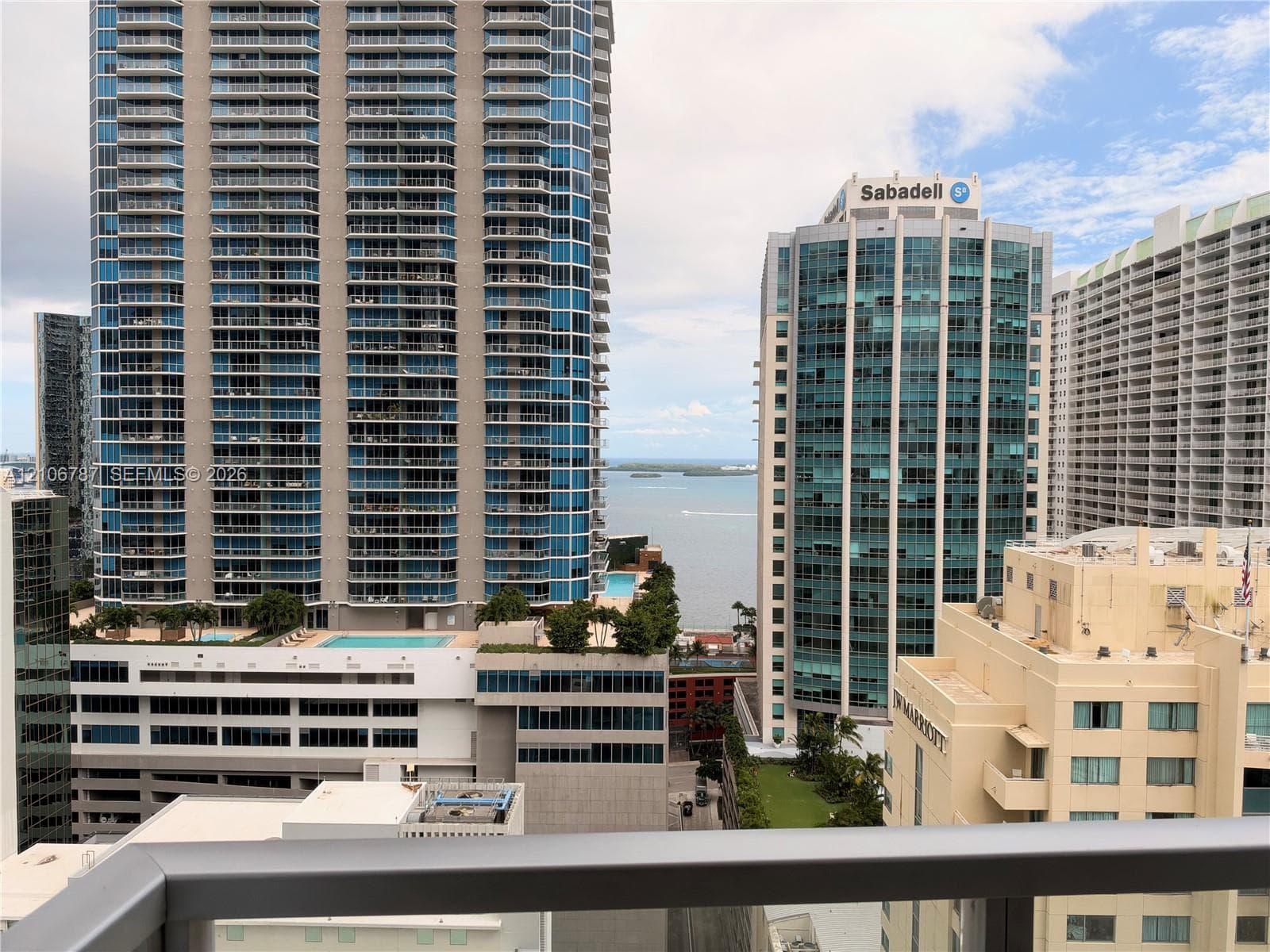 High-rise balcony featuring a metal railing and an urban cityscape outlook