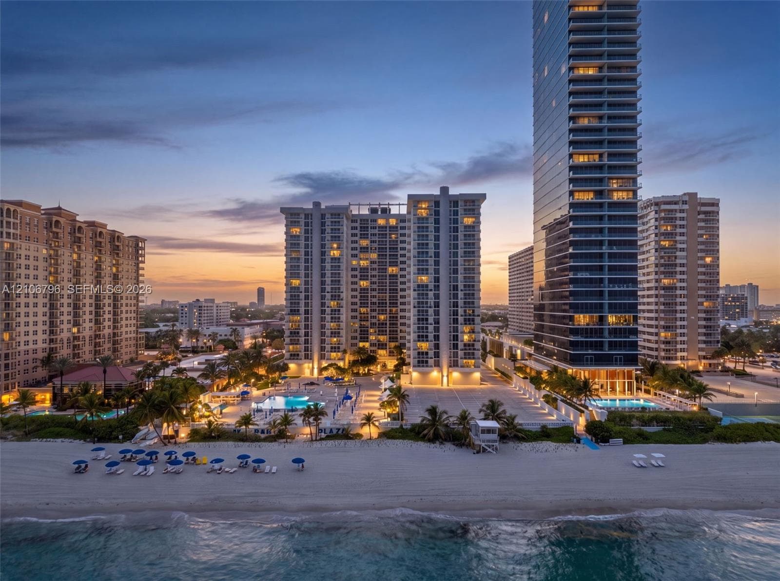 High-rise residential towers featuring direct beach access, multiple outdoor swimming pools, and landscaped grounds