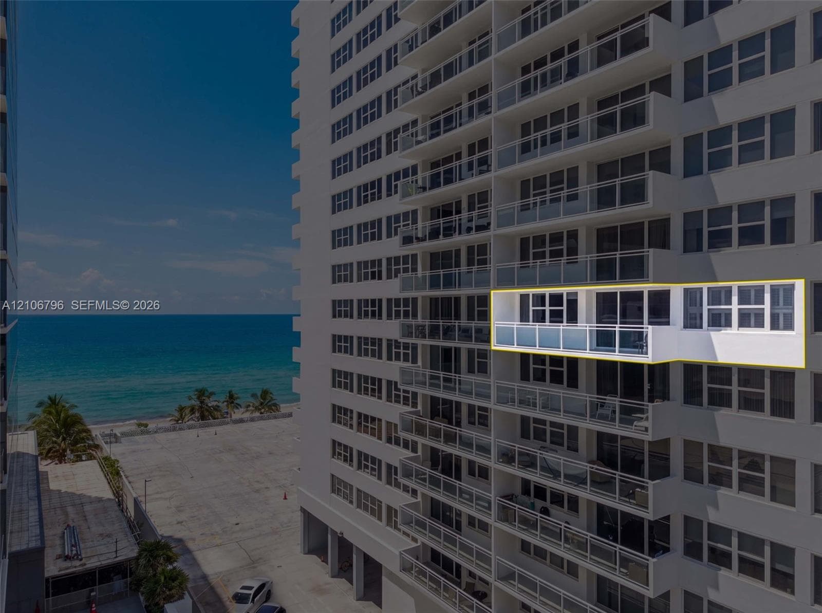 High-rise building exterior featuring glass balcony railings and sliding floor-to-ceiling windows