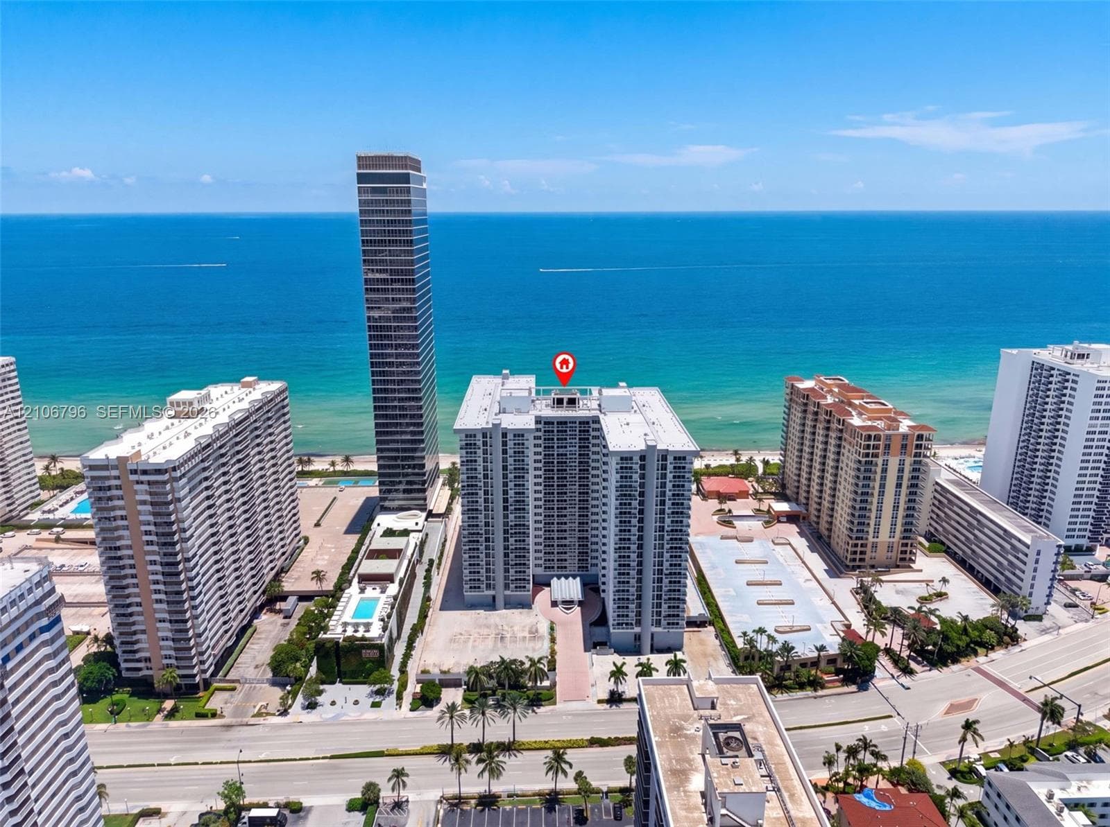 High-rise coastal property featuring direct oceanfront positioning, private balconies, and proximity to expansive sandy beaches