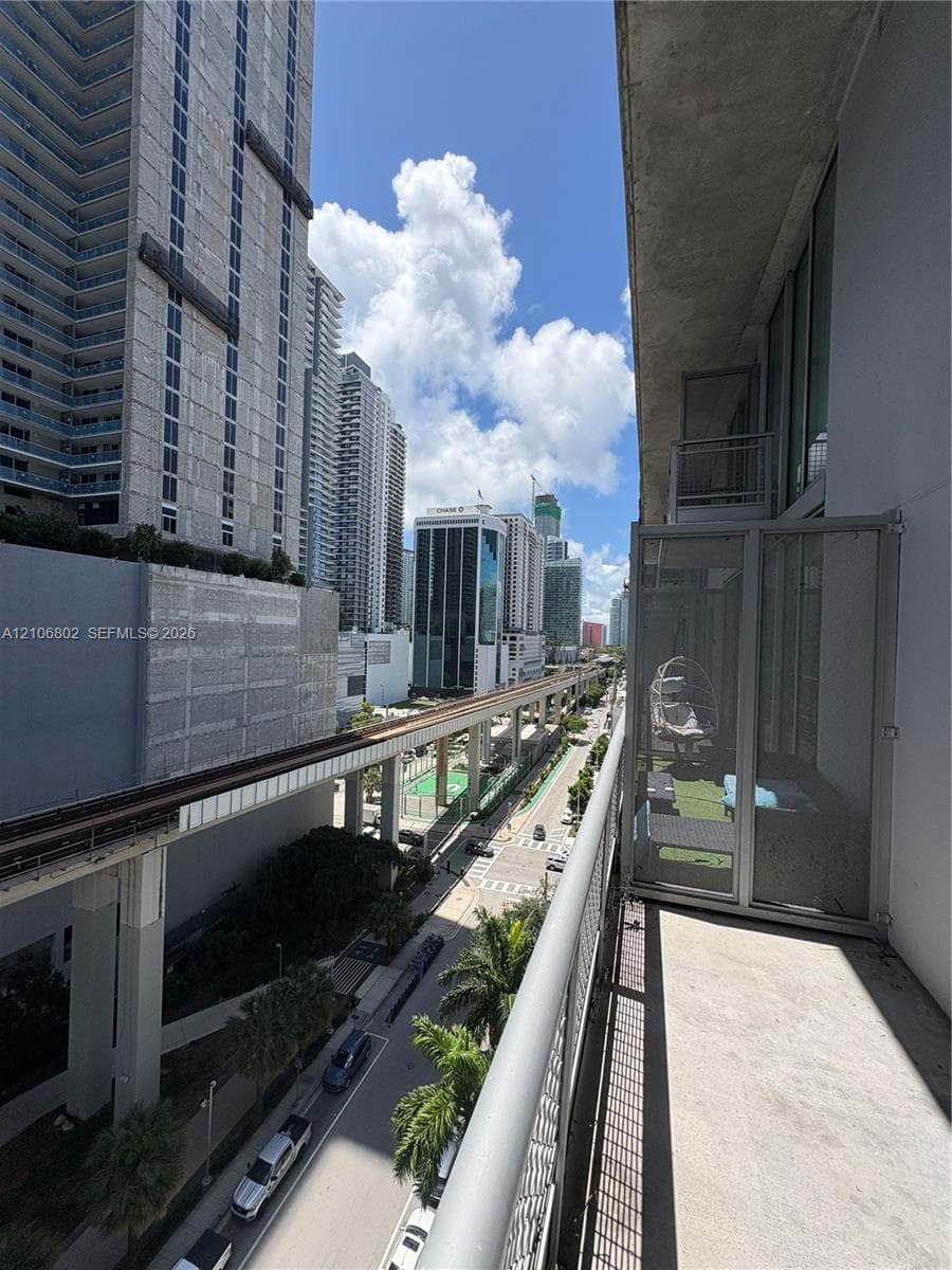 Private balcony featuring concrete flooring and metal railings