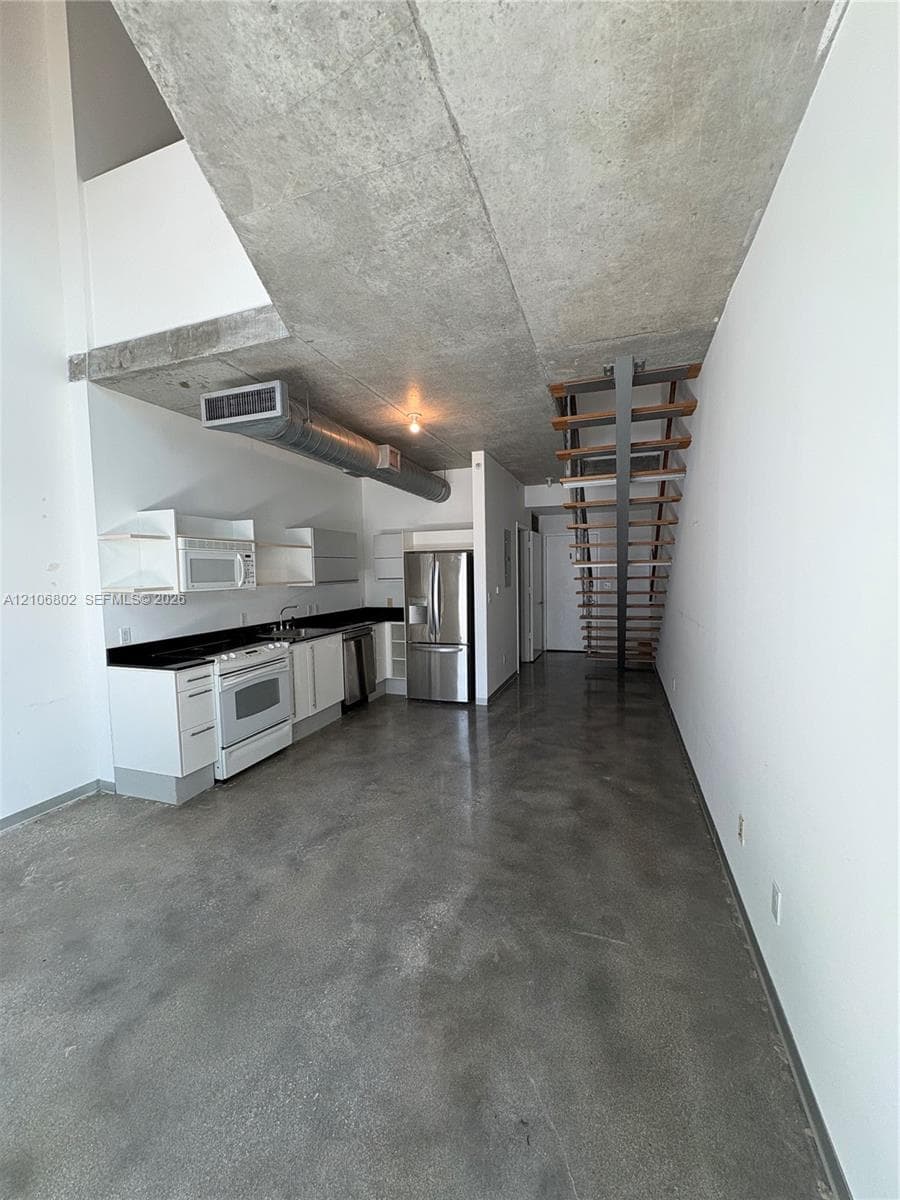 Industrial-style interior featuring exposed concrete ceilings and polished concrete flooring