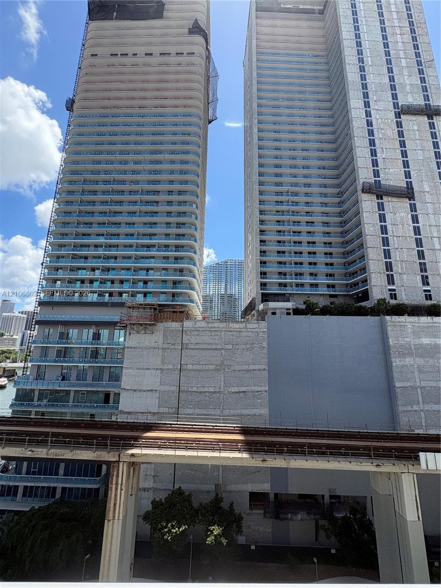 High-rise residential towers featuring glass-paneled balconies and concrete construction