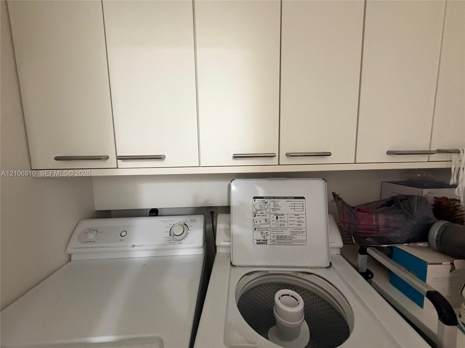 Wall-mounted cabinetry featuring flat-panel doors and brushed metal pulls