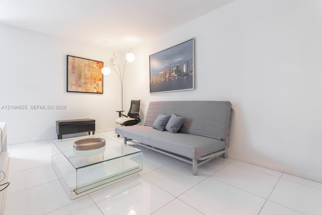 Bright interior space featuring polished white tile flooring and neutral walls