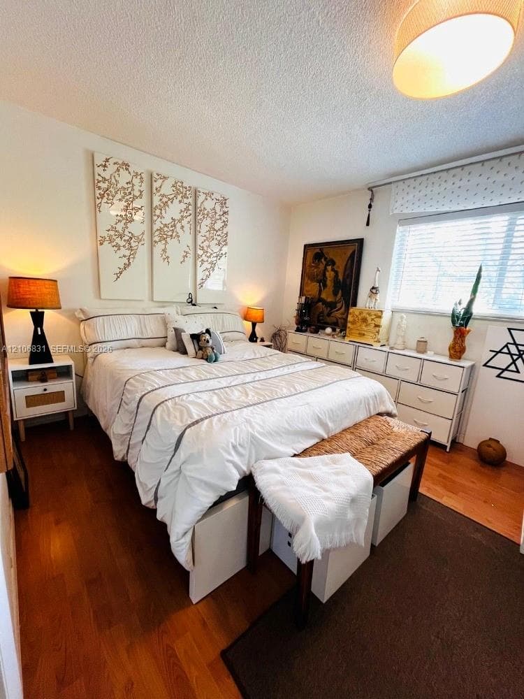 Wood-finish flooring, ceiling-mounted light fixture, and horizontal blind window treatment