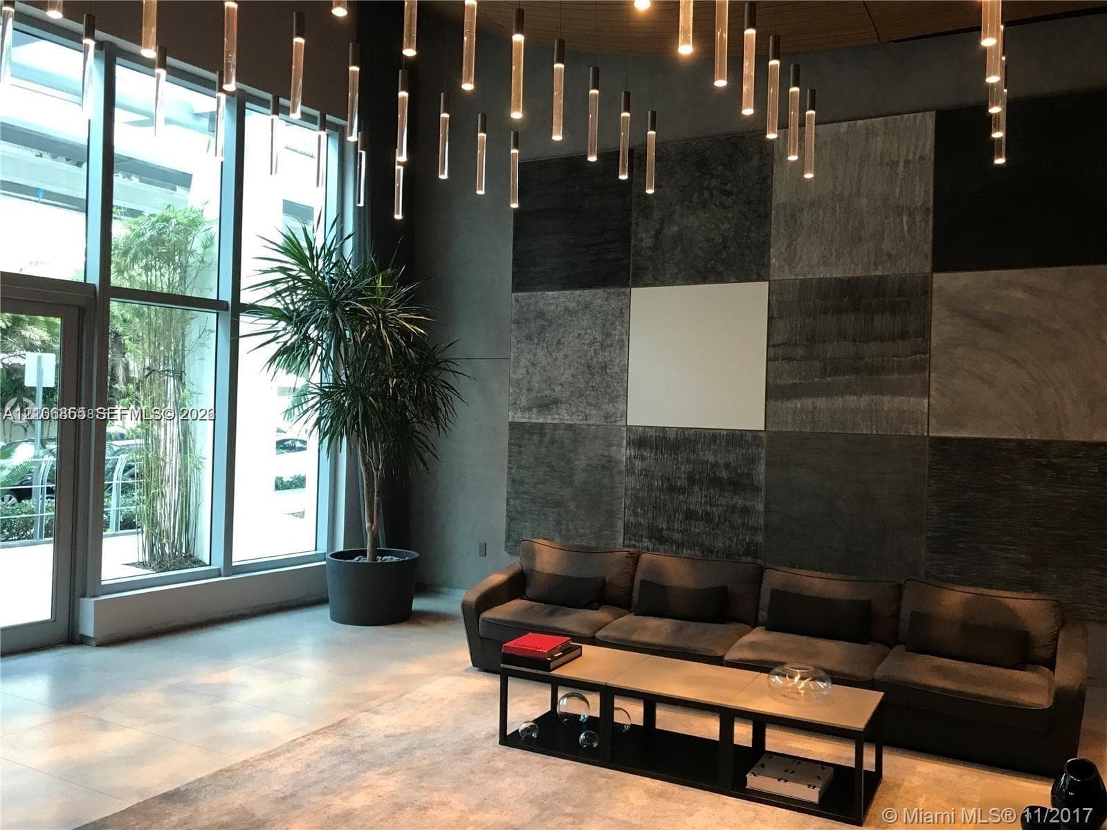 Floor-to-ceiling custom built-in shelving with grey finish and wood-finish flooring
