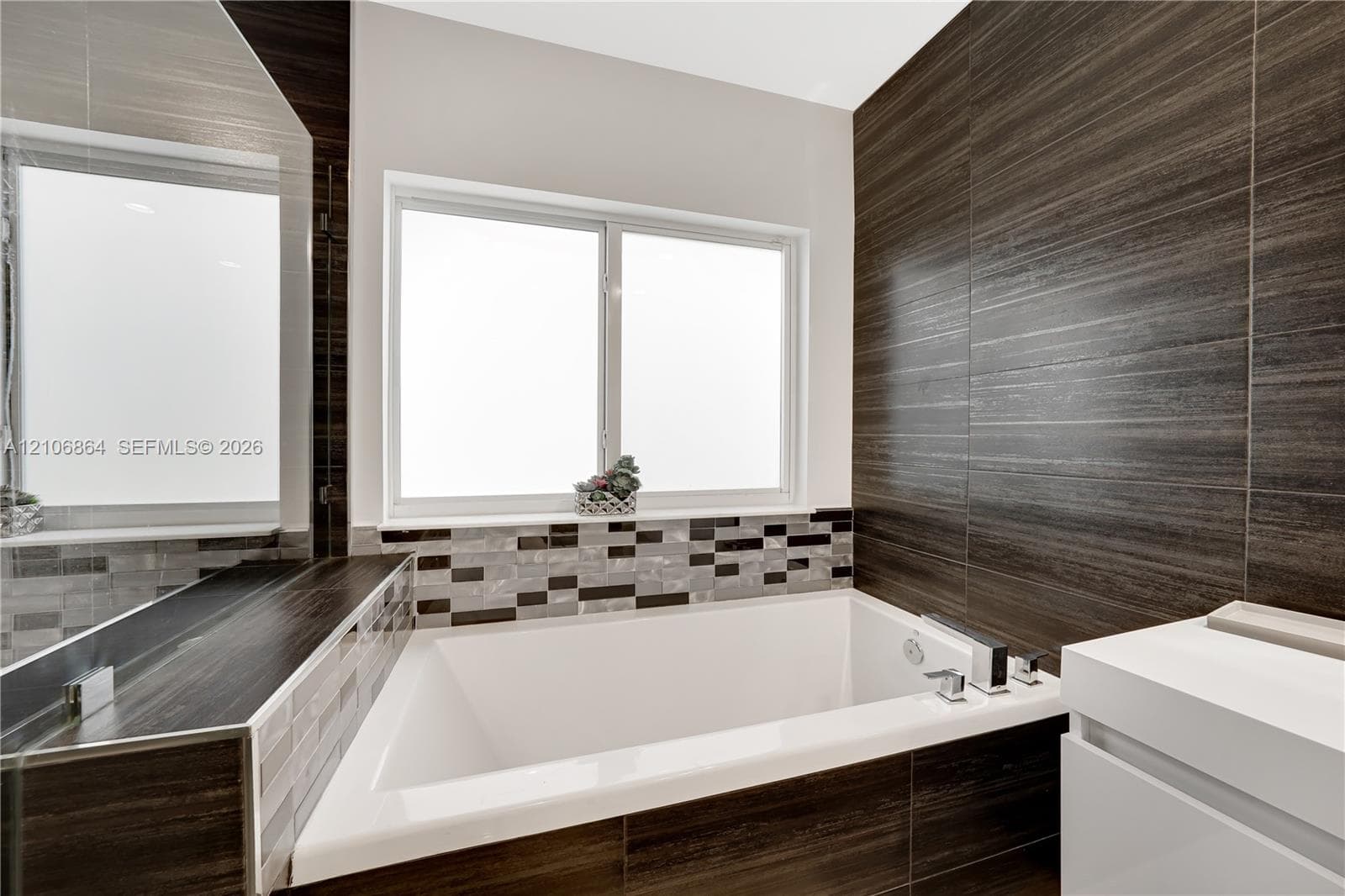 Neutral-toned room featuring high-gloss flooring, recessed lighting, a modern ceiling fan, and large windows providing natural light