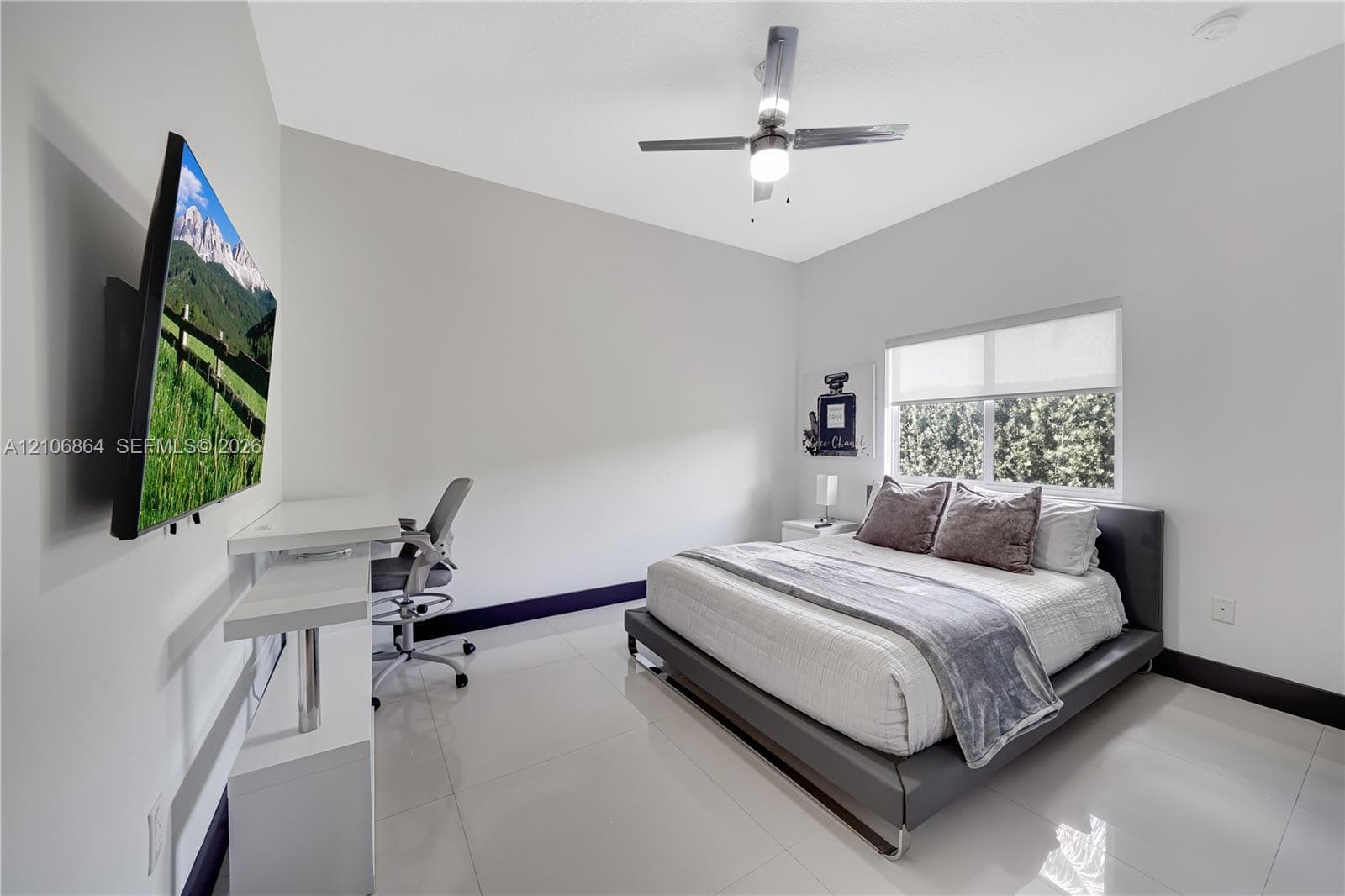 Neutral interior featuring high-gloss tile flooring, smooth wall finish, recessed ceiling lighting, and a window with a retractable roller shade