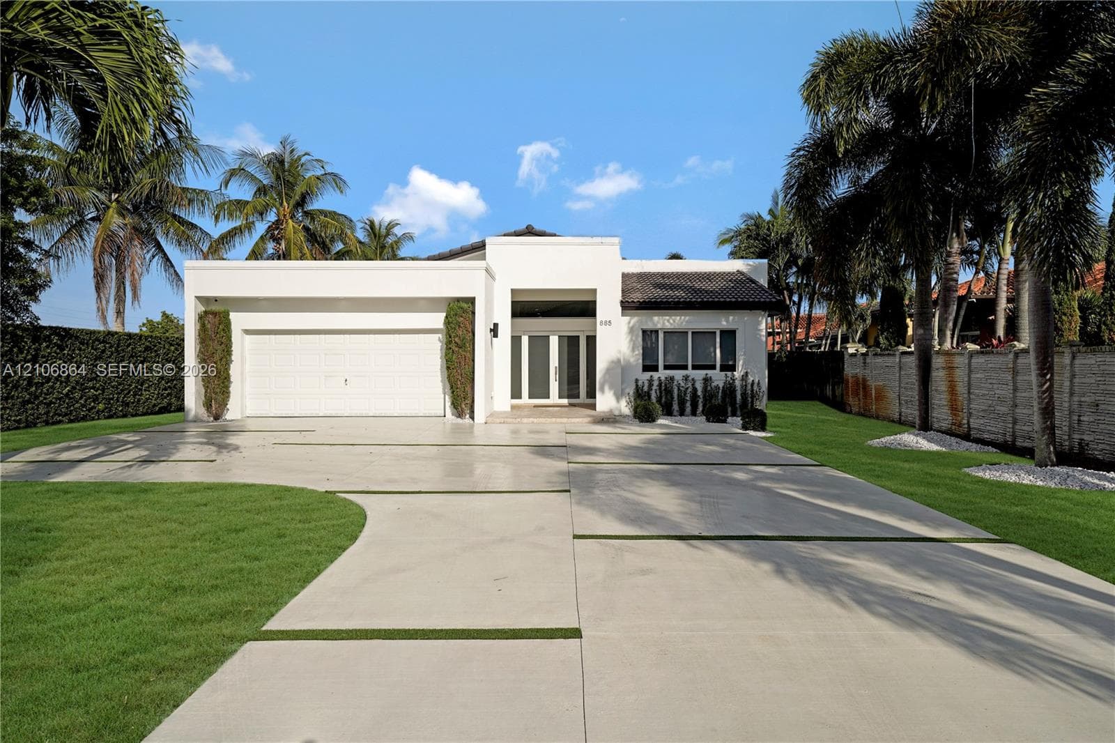 Open-concept living space featuring high ceilings, recessed lighting, and polished stone flooring throughout