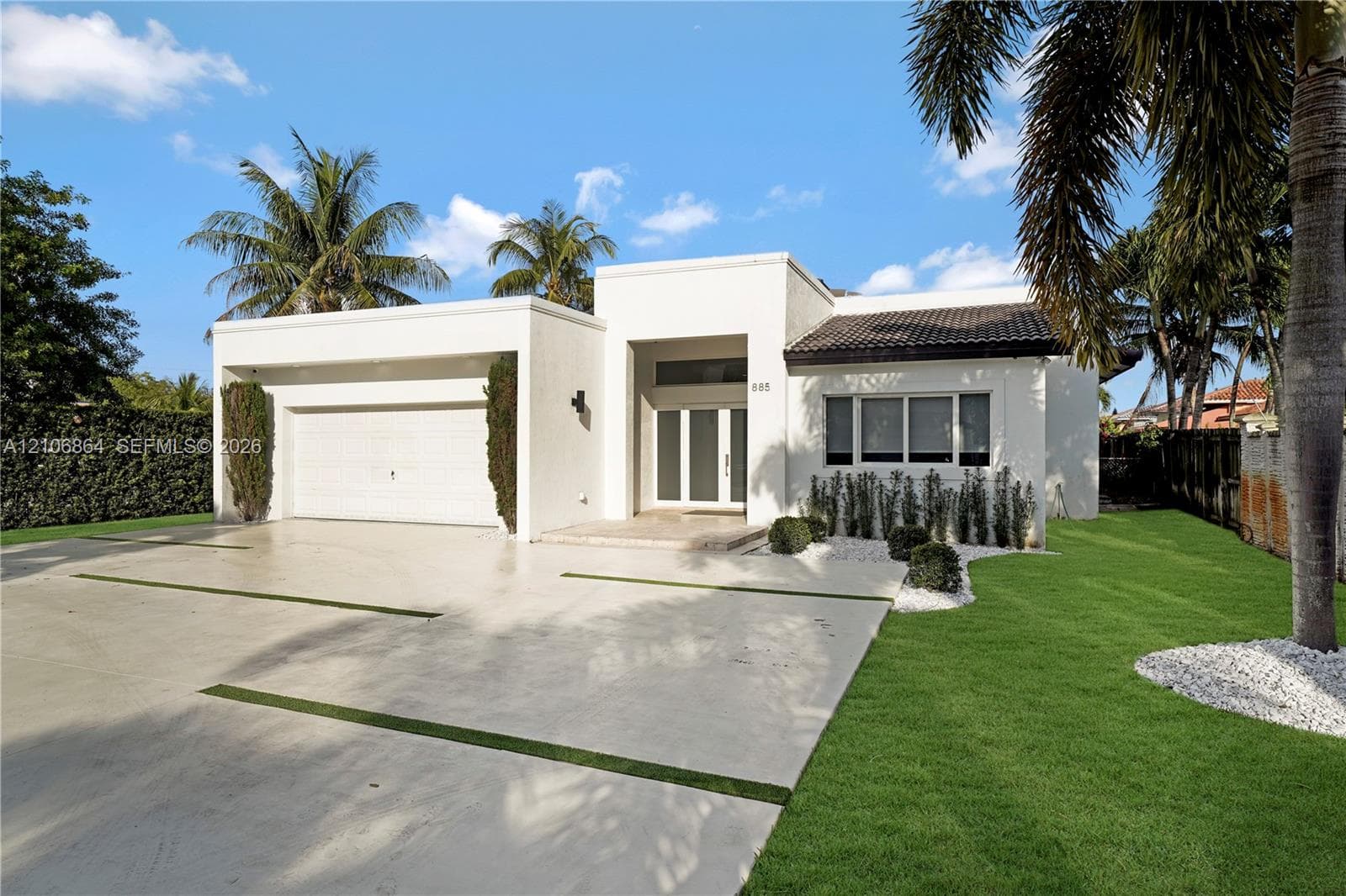Open interior space featuring high ceilings, polished tile flooring, recessed lighting, and expansive glass-paned double doors
