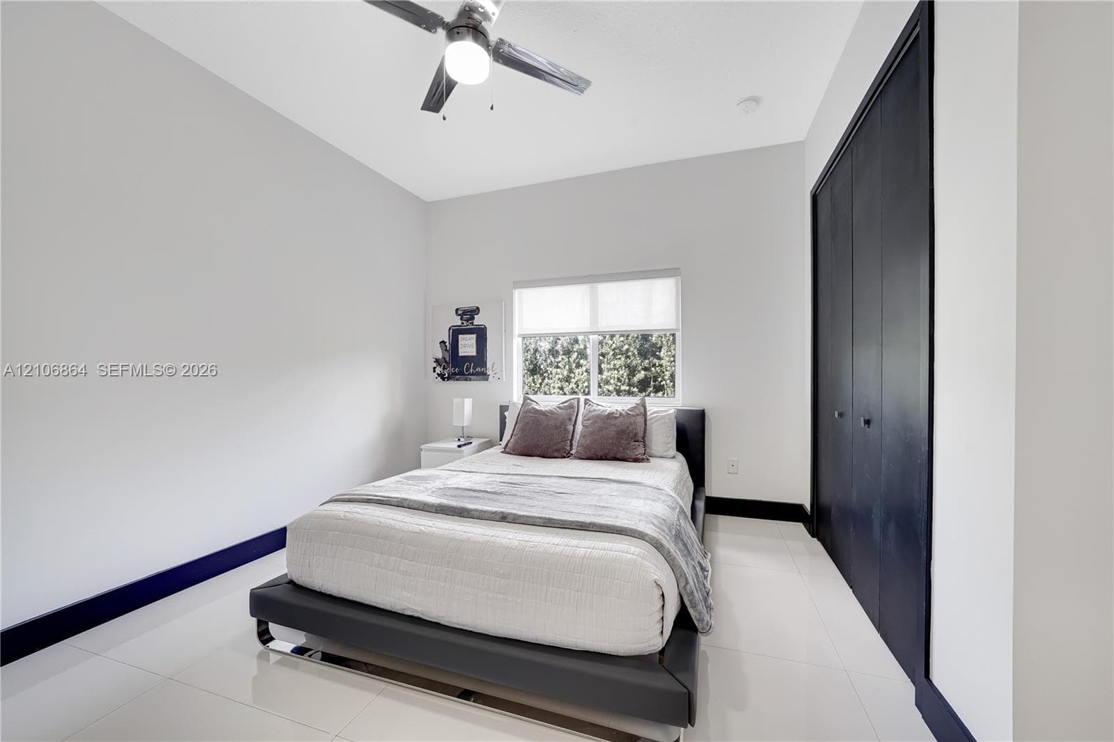 Laundry area featuring dark metallic-finish washer and dryer units with digital control panels and clear-view glass doors