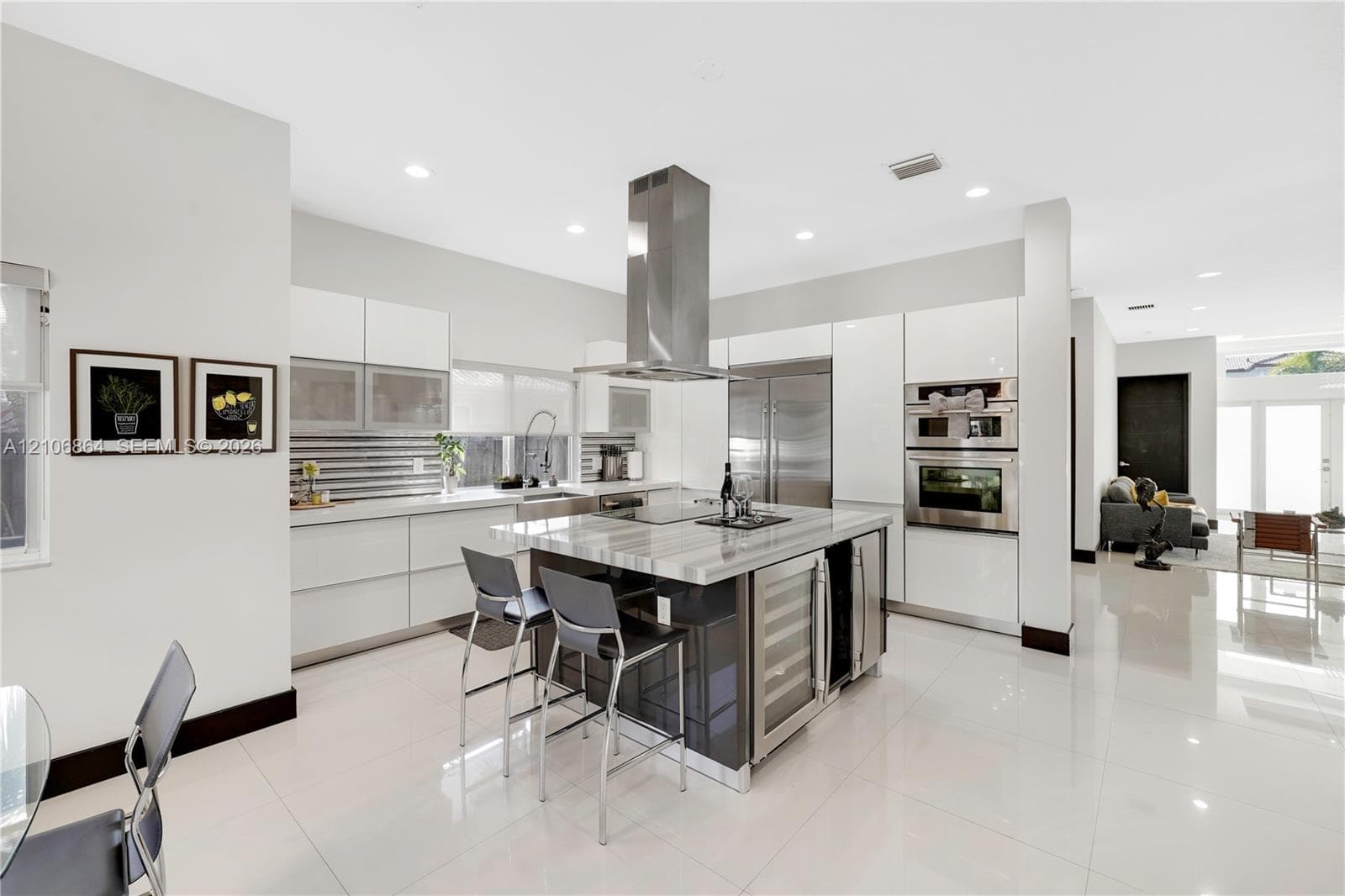Spacious room featuring a deep tray ceiling, high-gloss tile flooring, and three horizontal clerestory windows