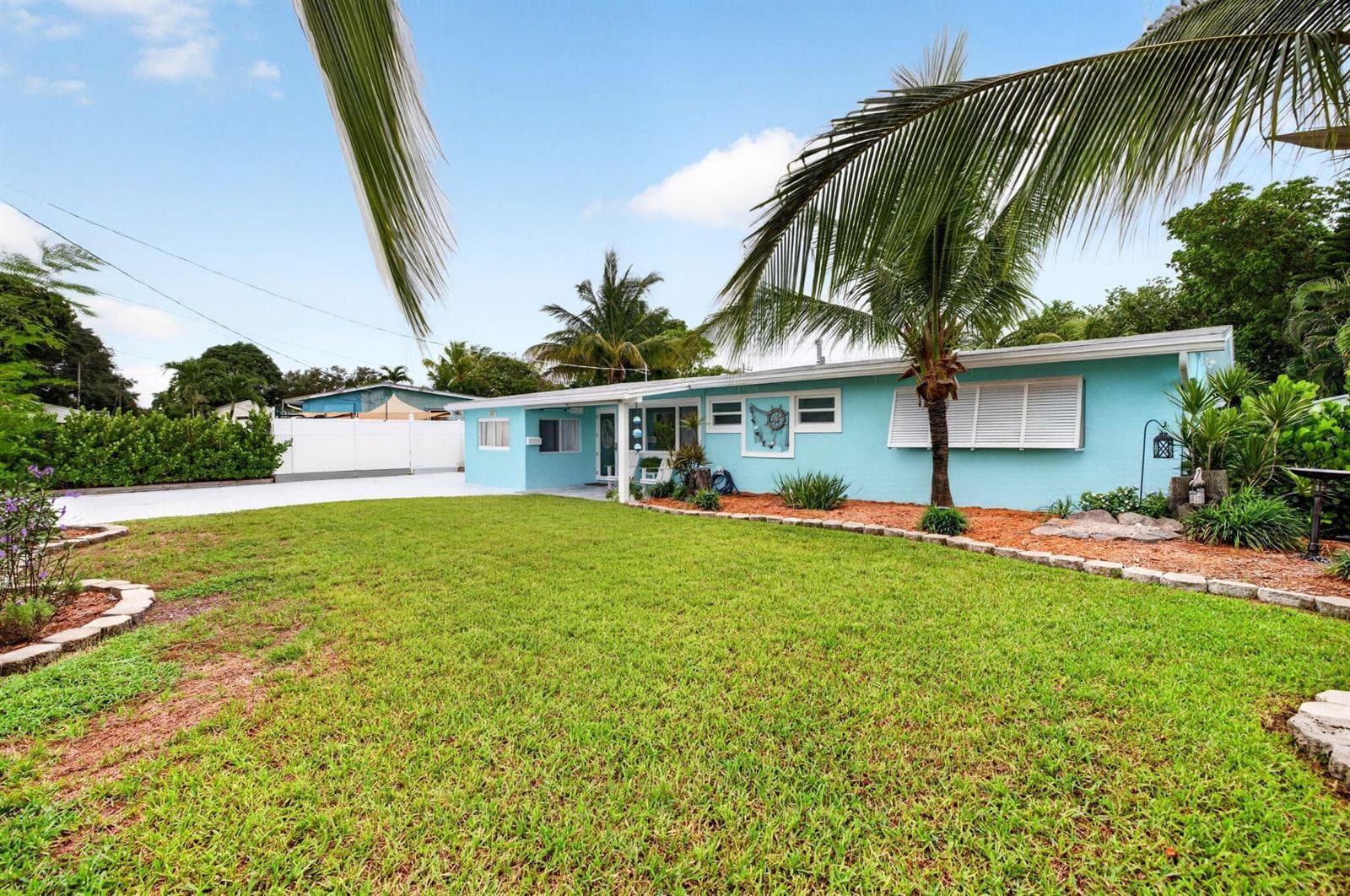 Large front yard with tropical plants