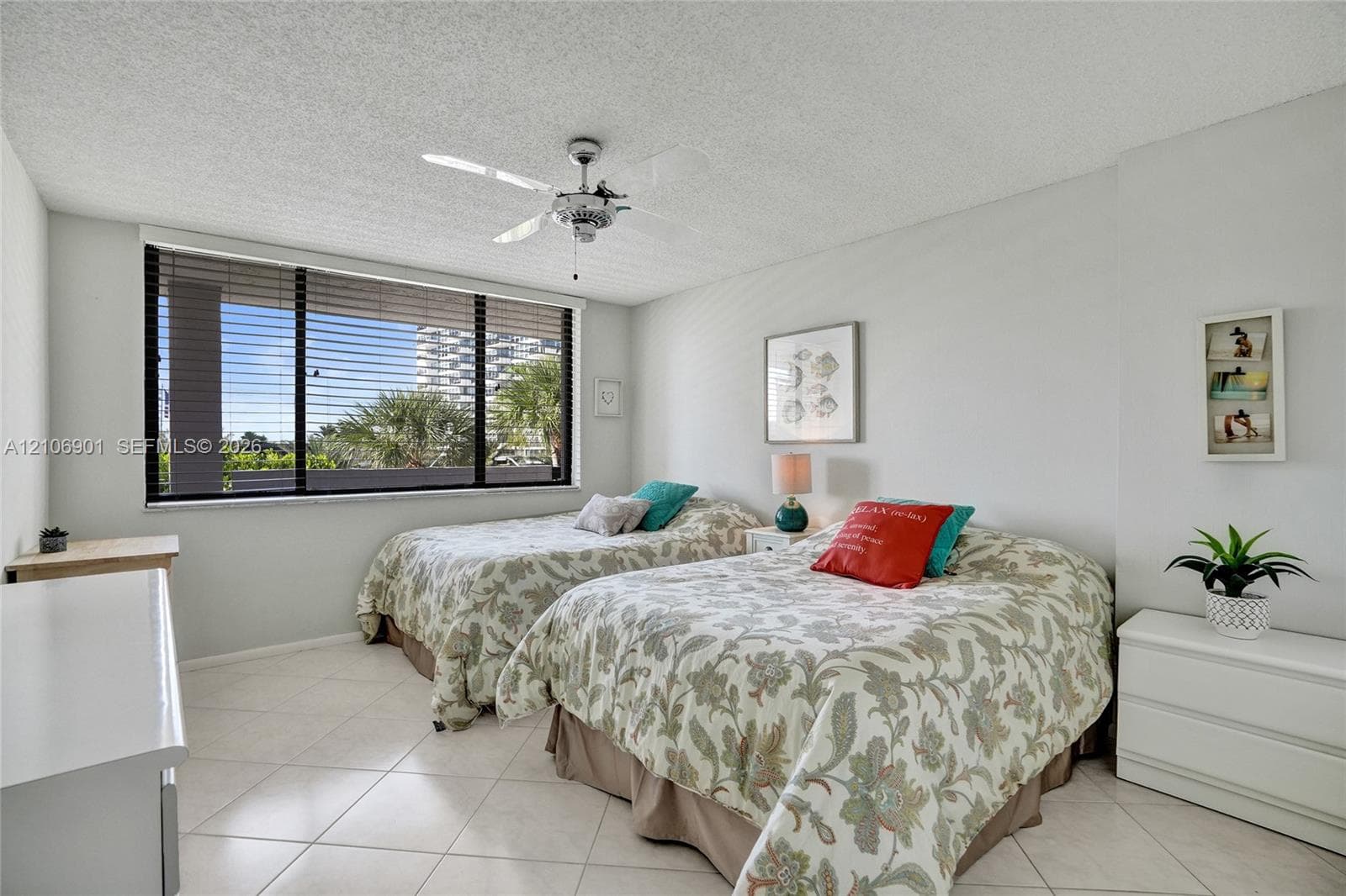Large windows, tile flooring, and a ceiling-mounted light fixture with fan