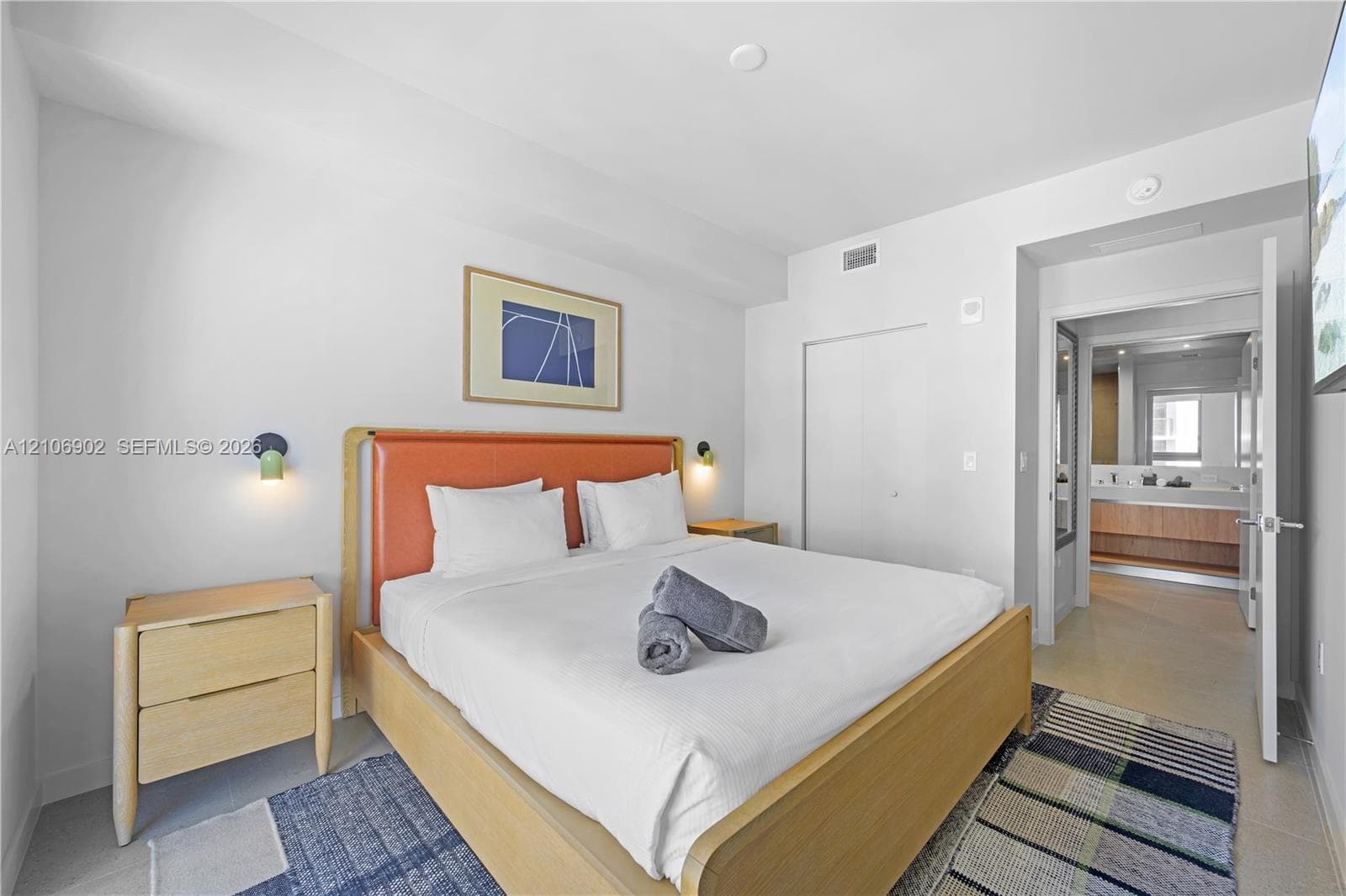 Neutral-toned room featuring a smooth finish, two wall-mounted accent sconces, and high-gloss interior doors