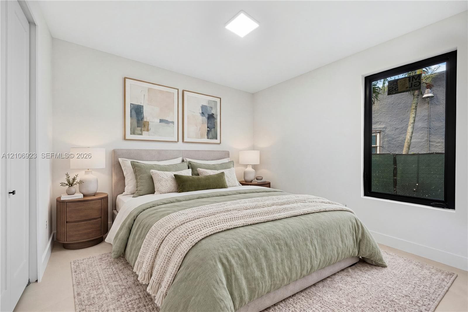 Neutral wall palette featuring high-contrast black window framing, clean-lined recessed lighting, and soft-toned wall-to-wall carpeting