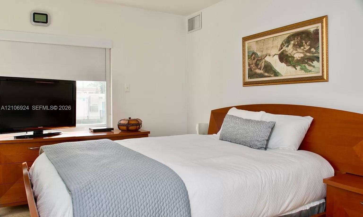 Neutral-toned room featuring a window with an integrated roller shade