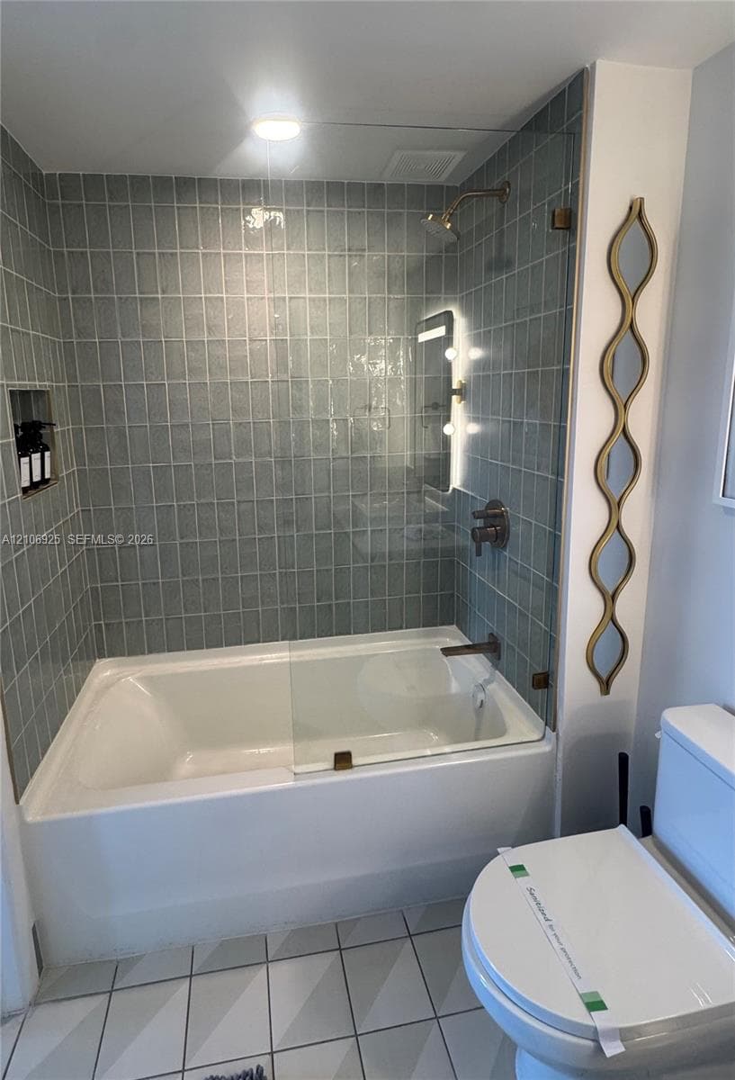 Neutral-toned tile flooring, white wall finishes, and integrated wall-mounted lighting