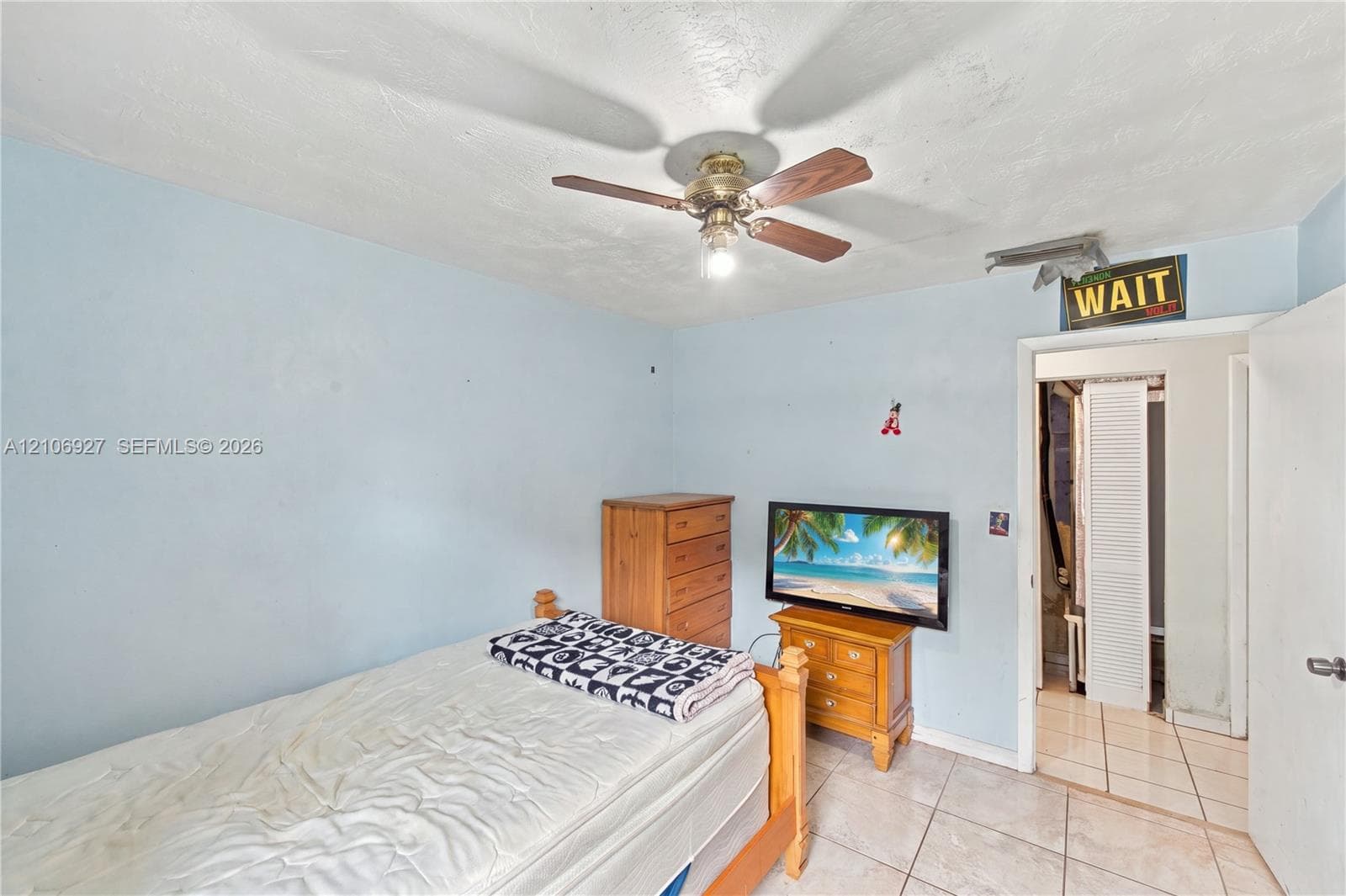 Room featuring tile flooring and a ceiling-mounted fan with light fixture