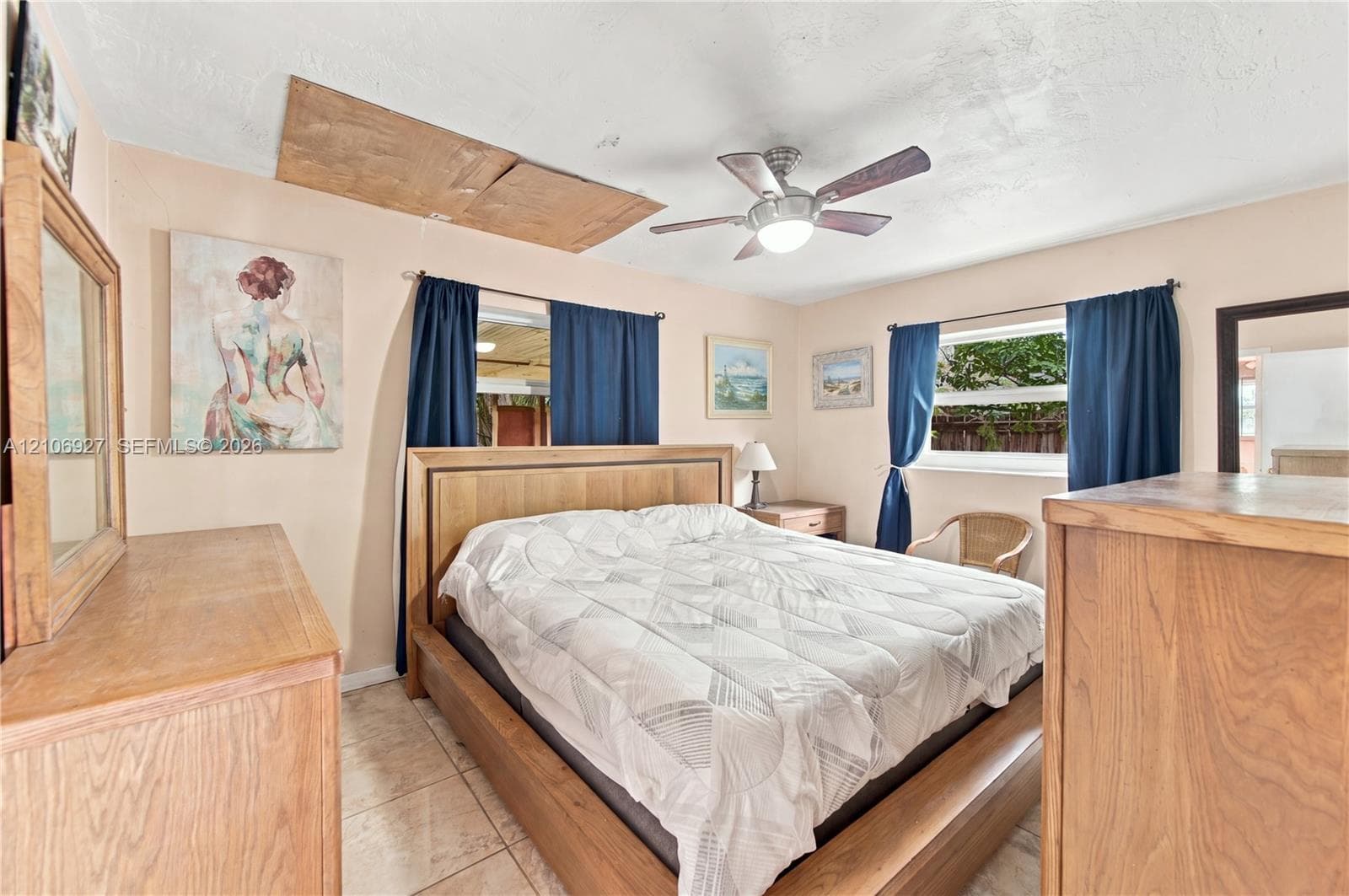 Interior space featuring ceramic tile flooring, a multi-blade ceiling fan with integrated lighting, and multiple windows
