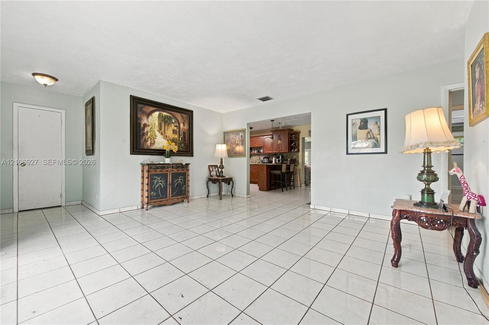 Living area featuring large-format ceramic tile flooring, neutral wall tones, and recessed lighting