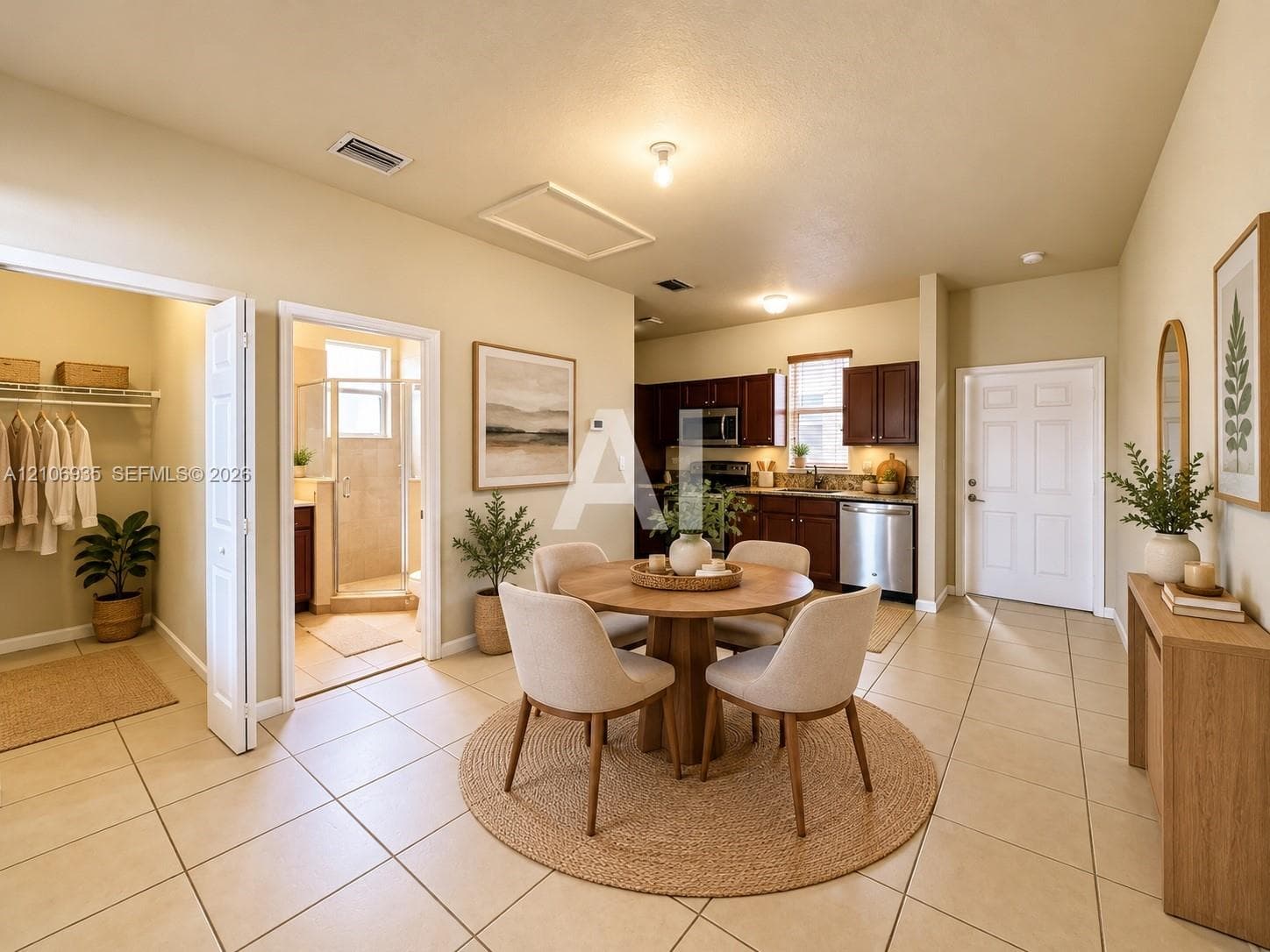 Kitchen featuring dark-finish cabinetry, stainless steel appliances, and tile flooring, with an adjoining closet and bathroom access