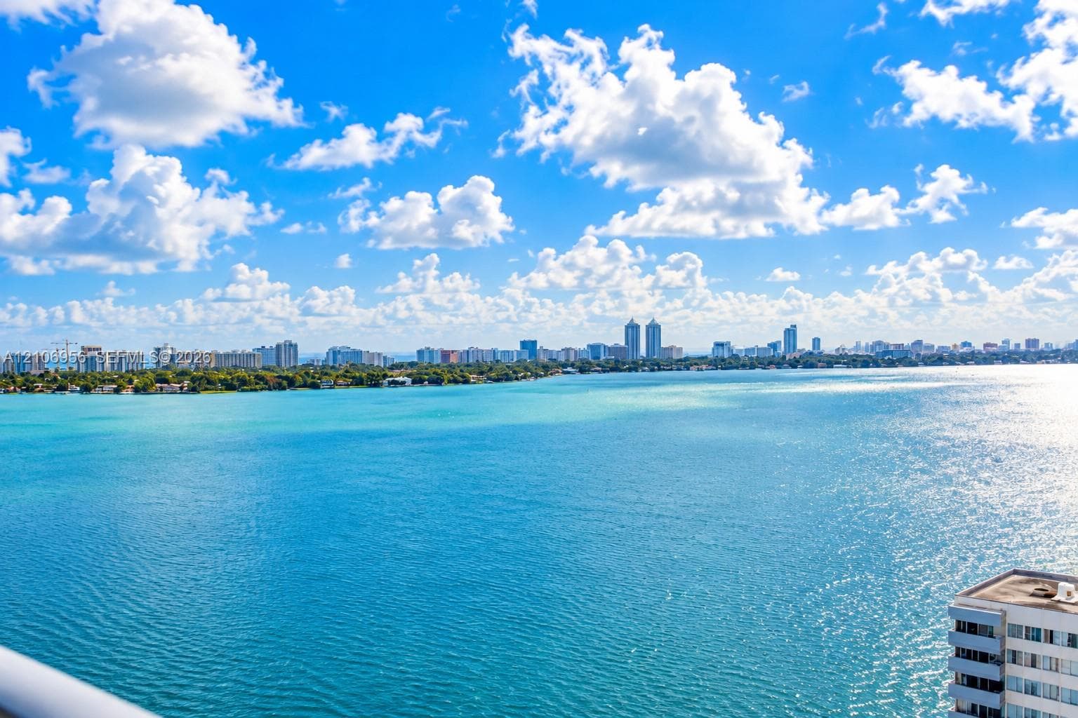 Expansive waterfront panorama showcasing a bay and distant cityscape