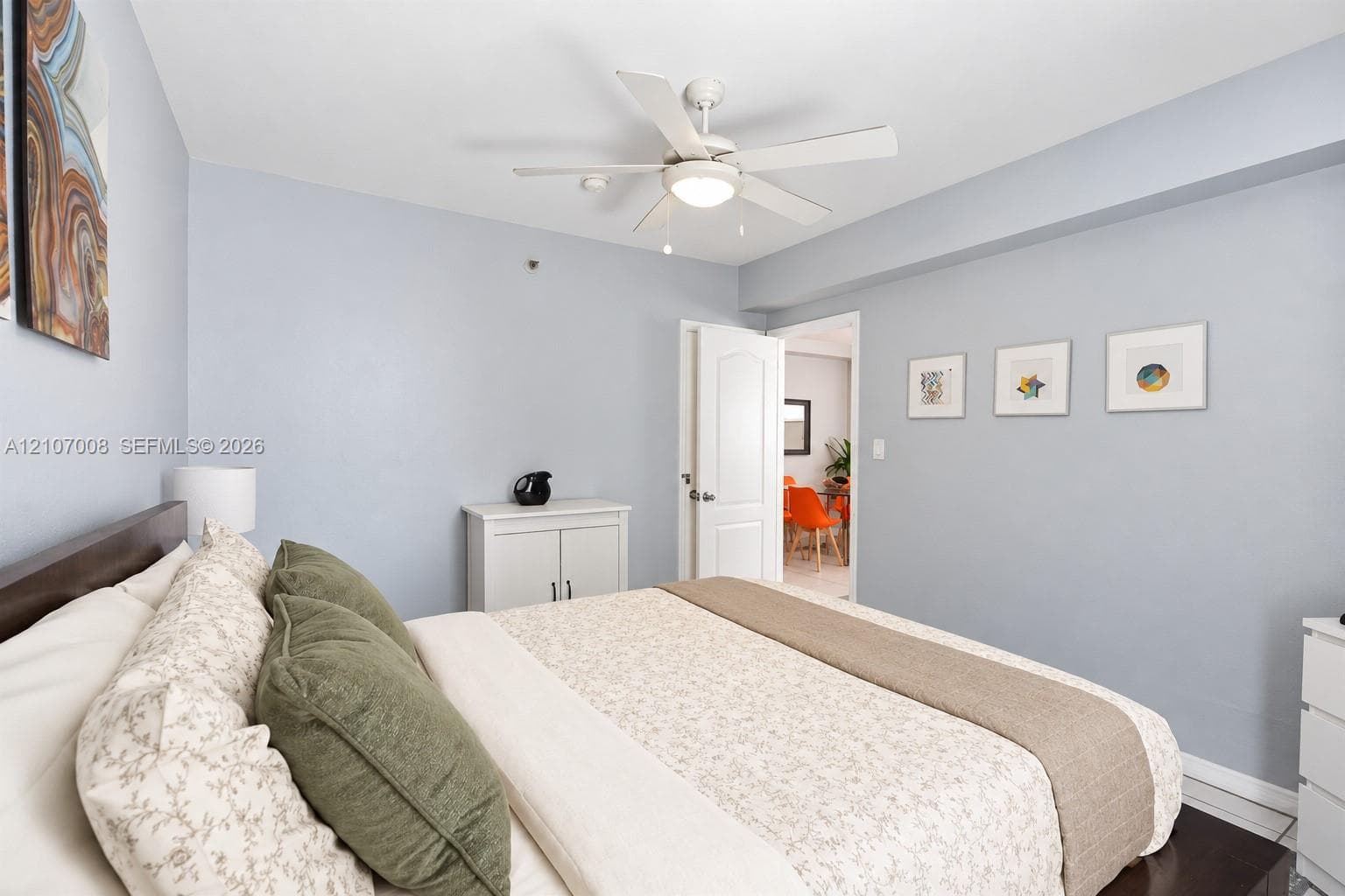 Room featuring a ceiling fan with integrated lighting and a multi-panel door