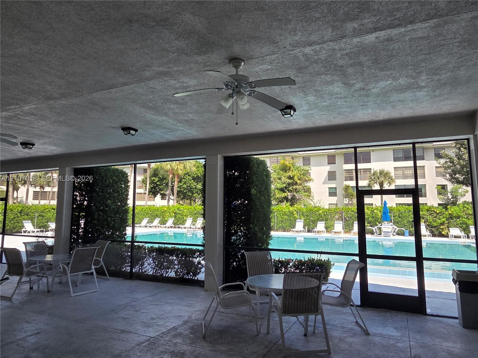 Covered outdoor patio featuring a concrete floor, built-in ceiling fans, recessed lighting, and a screened enclosure