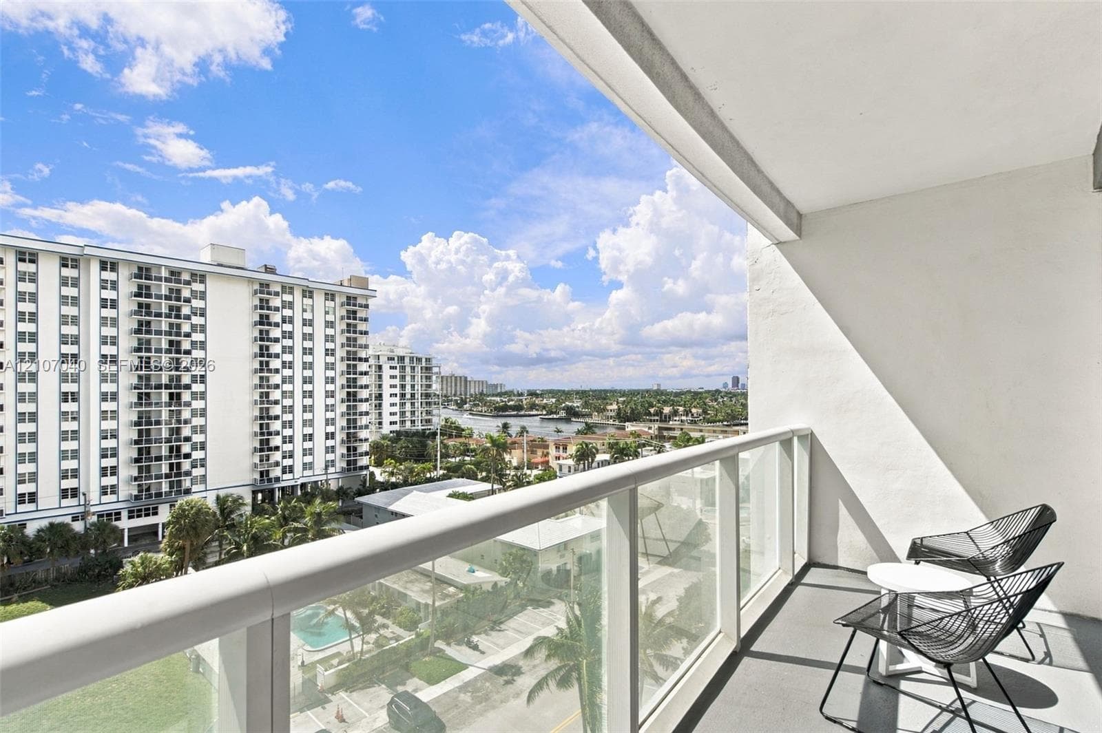 Private balcony featuring a glass-panel railing and concrete flooring