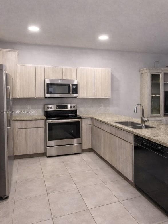 Kitchen featuring light-finish cabinetry, stone-texture countertops, recessed lighting, tile flooring, and stainless steel appliances