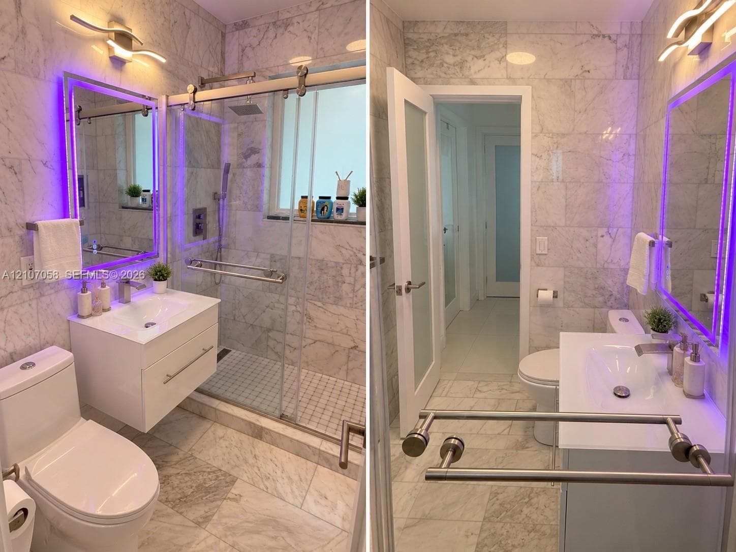 Bathroom featuring floor-to-ceiling stone tile, a modern floating vanity with a white countertop, a walk-in shower with a sliding glass door, and integrated LED vanity lighting