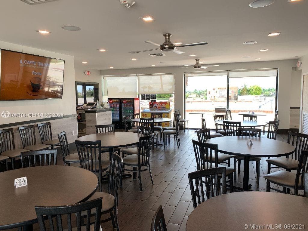 Interior space featuring wood-finish flooring, recessed ceiling lighting, ceiling fans, and floor-to-ceiling windows