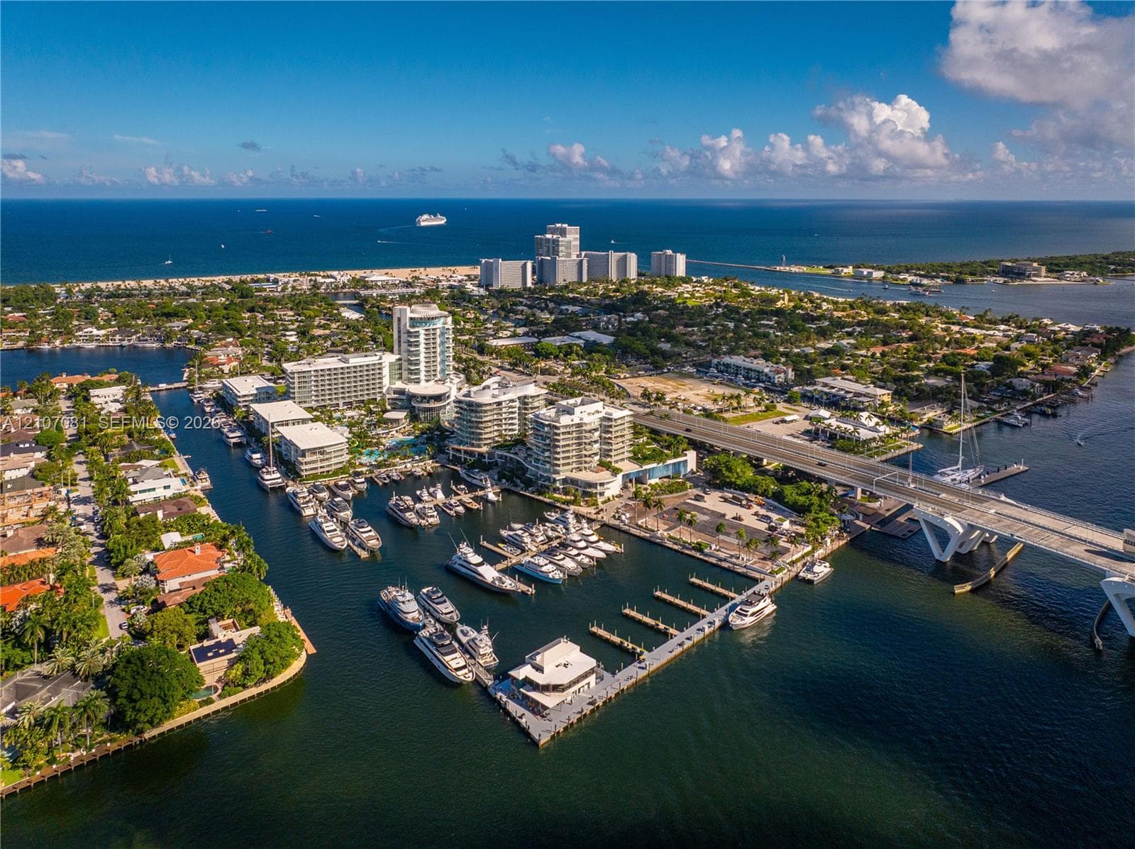 Aerial perspective of a coastal marina featuring deep-water slips, concrete docking infrastructure, and direct access to open water