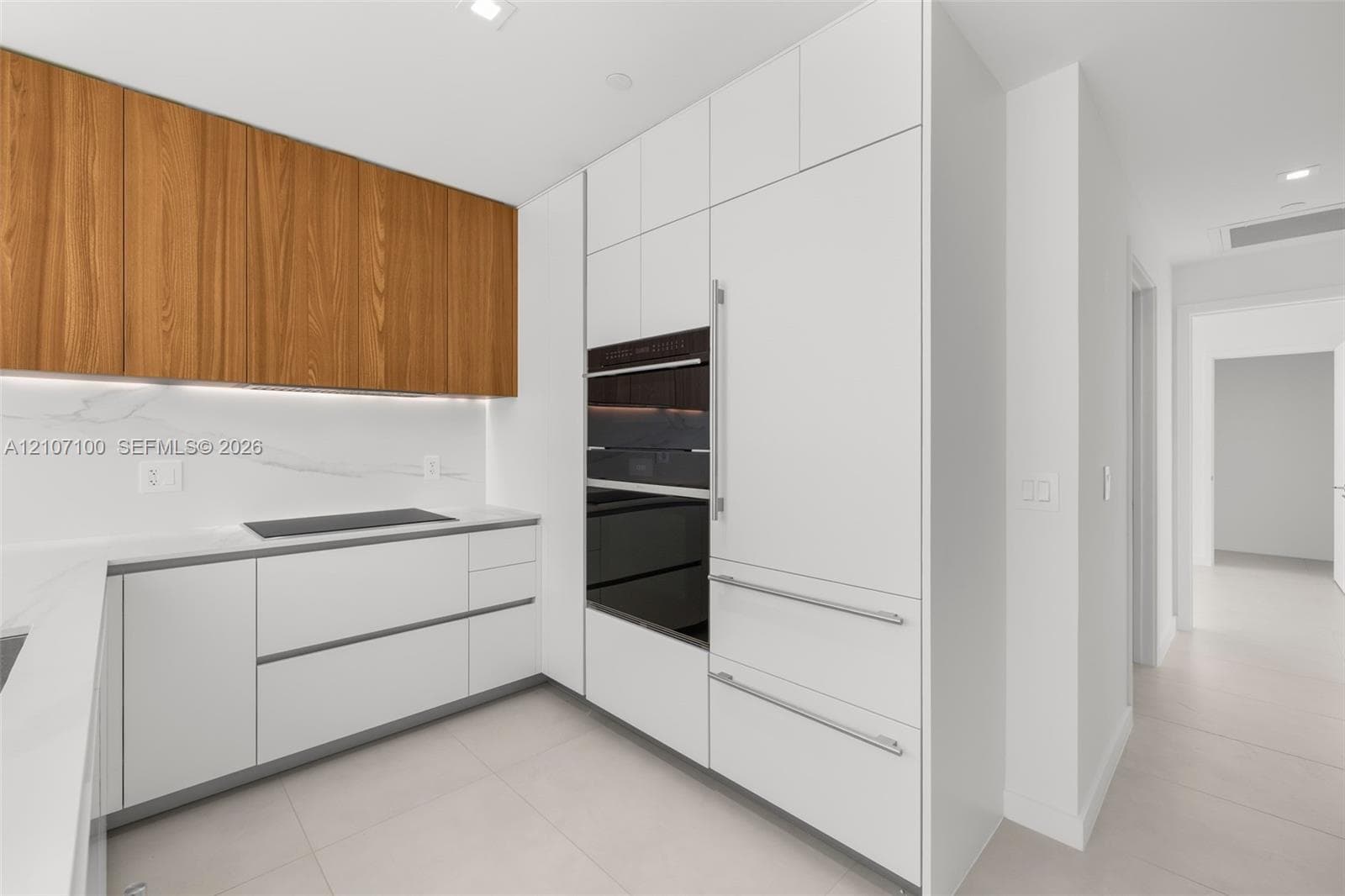 Entryway featuring large-format ceramic floor tiling, smooth-finish walls, and a recessed ceiling light fixture