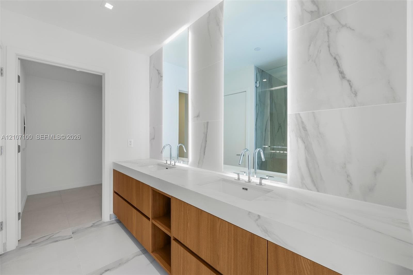 Minimalist interior featuring large-format ceramic tile flooring, smooth wall finish, and a solid-core interior door