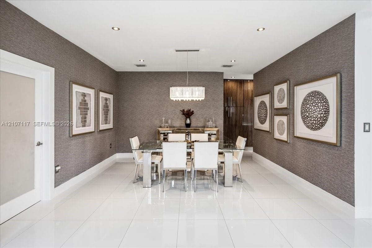 Large-format tile flooring, textured wall coverings, rectangular multi-tier chandelier, and recessed lighting