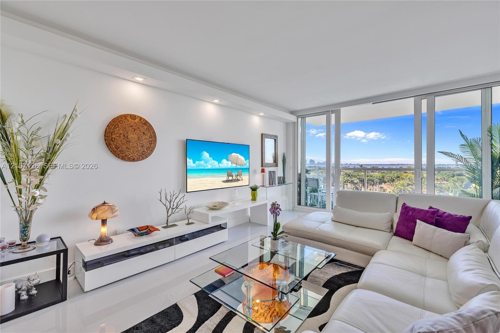Living area featuring floor-to-ceiling glass sliding doors, polished tile flooring, and recessed ceiling lighting
