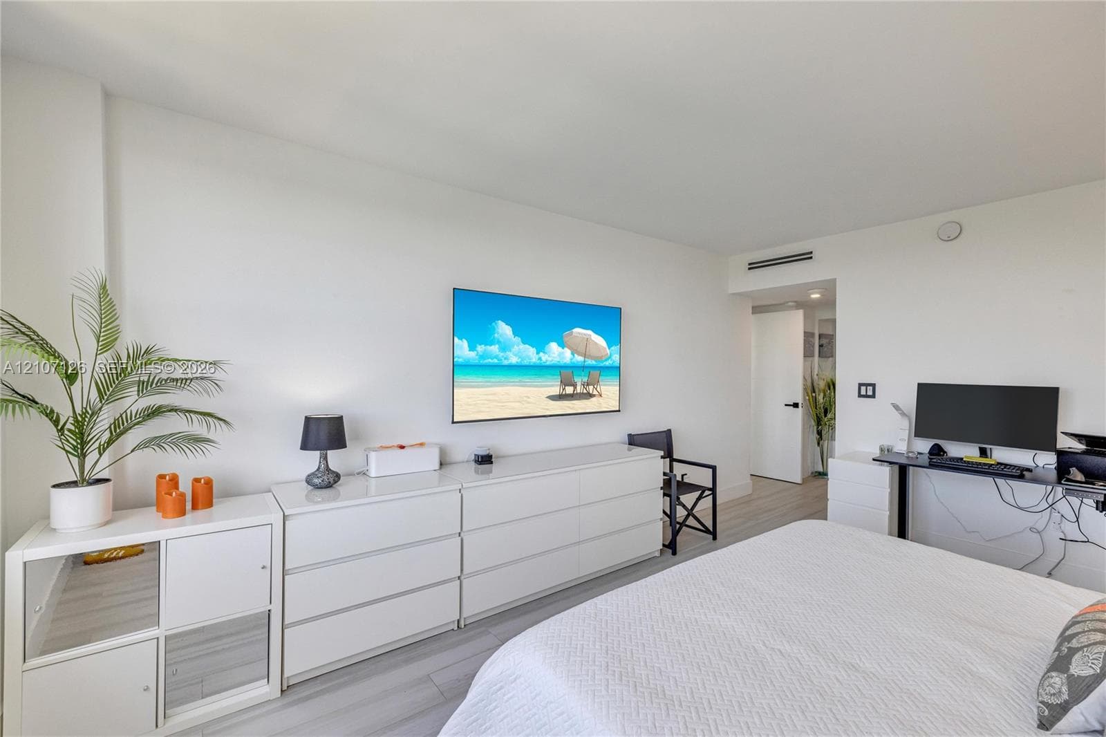Light-toned wood-finish flooring and neutral wall paint featuring recessed ceiling lighting